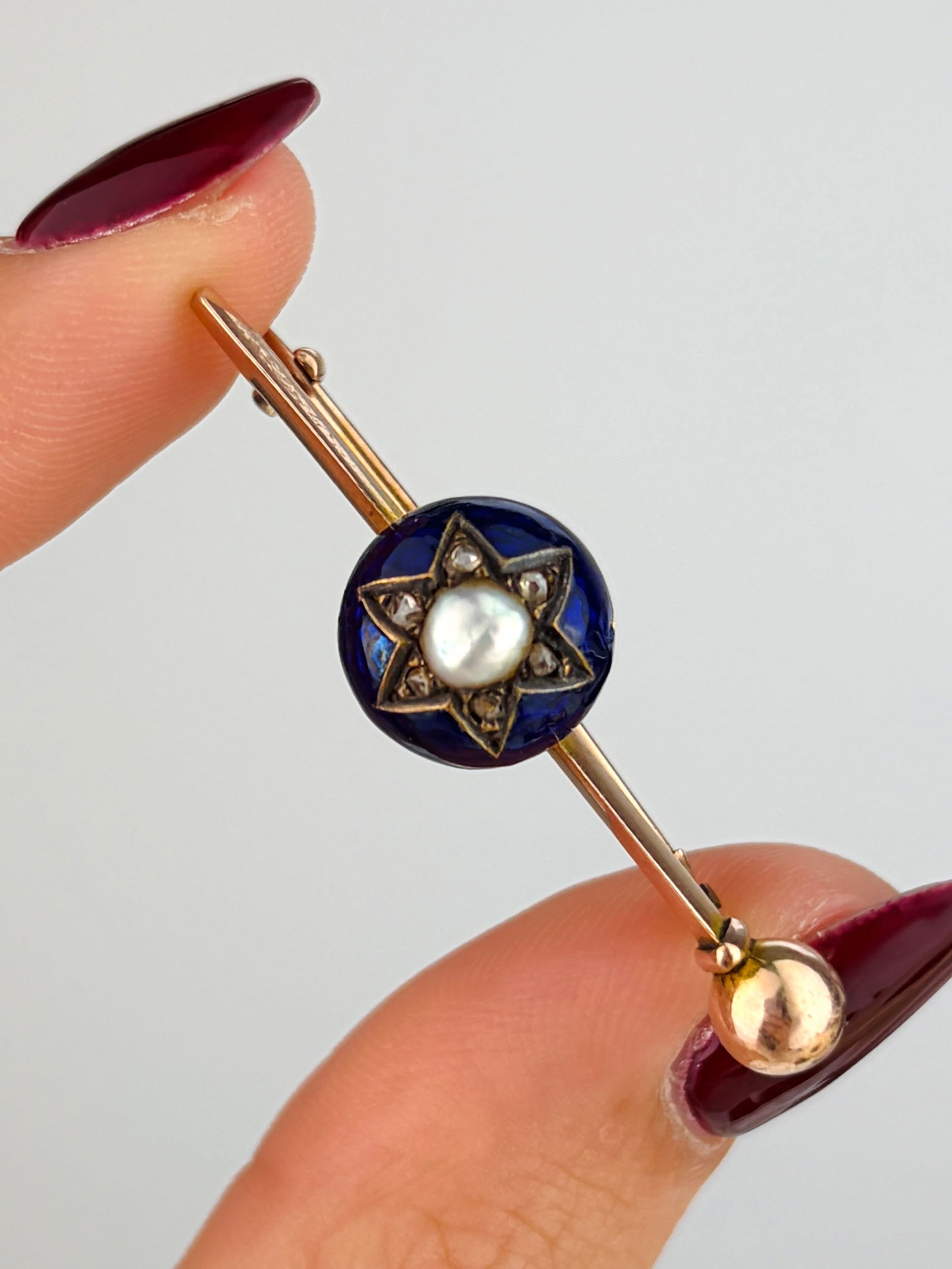 Antique 9ct Gold Blue Enamel, Rose Cut Diamond and Pearl Star Brooch: Antique 9ct Gold Blue Enamel, Rose Cut Diamond and Pearl Star Brooch Weight: 3.49g Size: 10x40mm, depth 8mm Materials: 9ct gold Hallmarks: 9ct stamp Condition: The overall condition is very