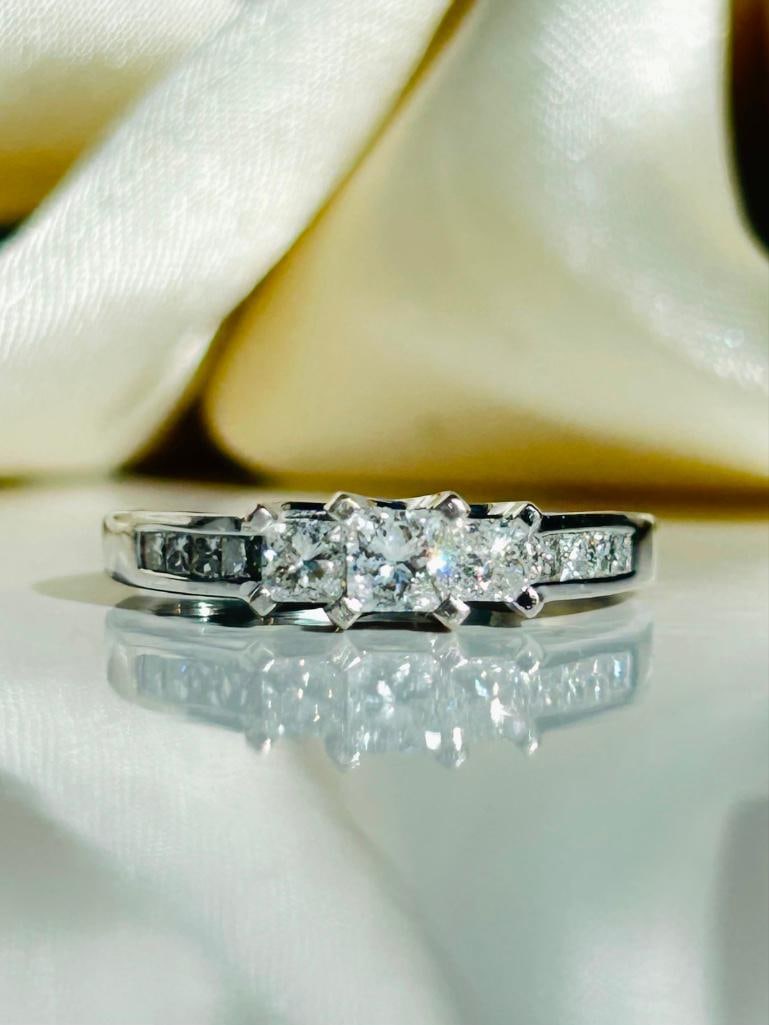 *Vintage Princess Cut Diamond and Platinum Three Stone Ring: Vintage Princess Cut Diamond and Platinum Three Stone Ring The sparkle of this ring is absolutely stunning! It holds three larger and more prominent princess diamonds which measure a total of