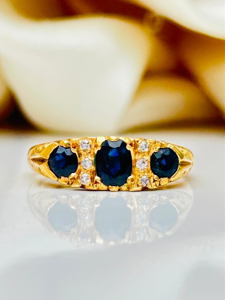 Chunky 18ct Yellow Gold Sapphire and Diamond 3 Stone Ring: Chunky 18ct Yellow Gold Sapphire and Diamond 3 Stone Ring gorgeous ring with a prettt scroll Measurements: size UK R US 83/4 head of ring 17mm x 6mm weight 5.29g