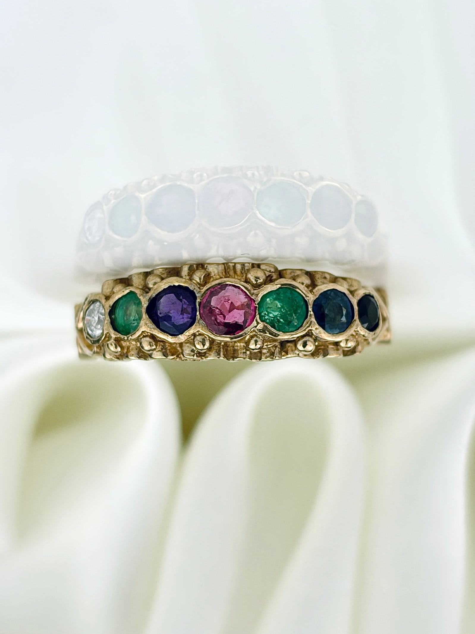 VINTAGE C.1970 'DEAREST' ACROSTIC RING IN 9CT YELLOW GOLD: VINTAGE C.1970 'DEAREST' ACROSTIC RING IN 9CT YELLOW GOLD A truly wonderful way to share a secret message, with heart shoulders! The stones are placed in order to read 'dearest' with the first letter