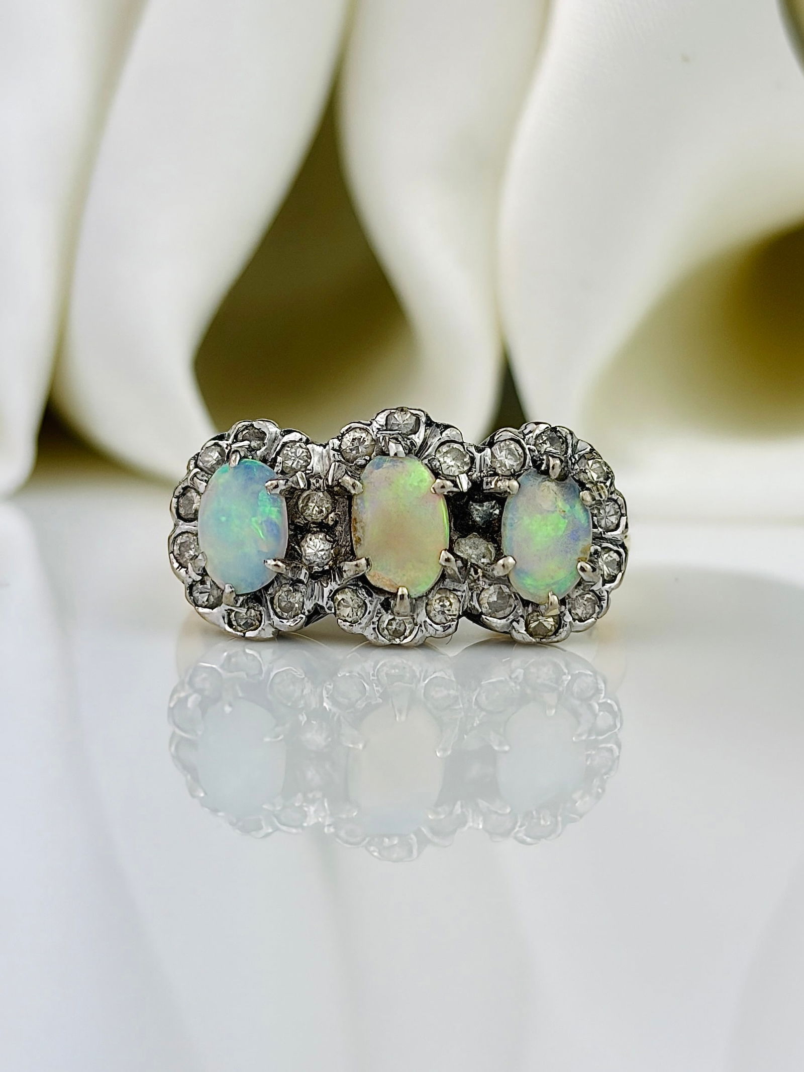 Vintage Opal and Diamond 18ct Gold and Platinum Triple Cluster Ring: Vintage Opal and Diamond 18ct Gold Triple Cluster Ring This stunning cluster ring holds three colourful opals, each surrounded by diamonds. The diamonds measure approximately 52pts total, and each op