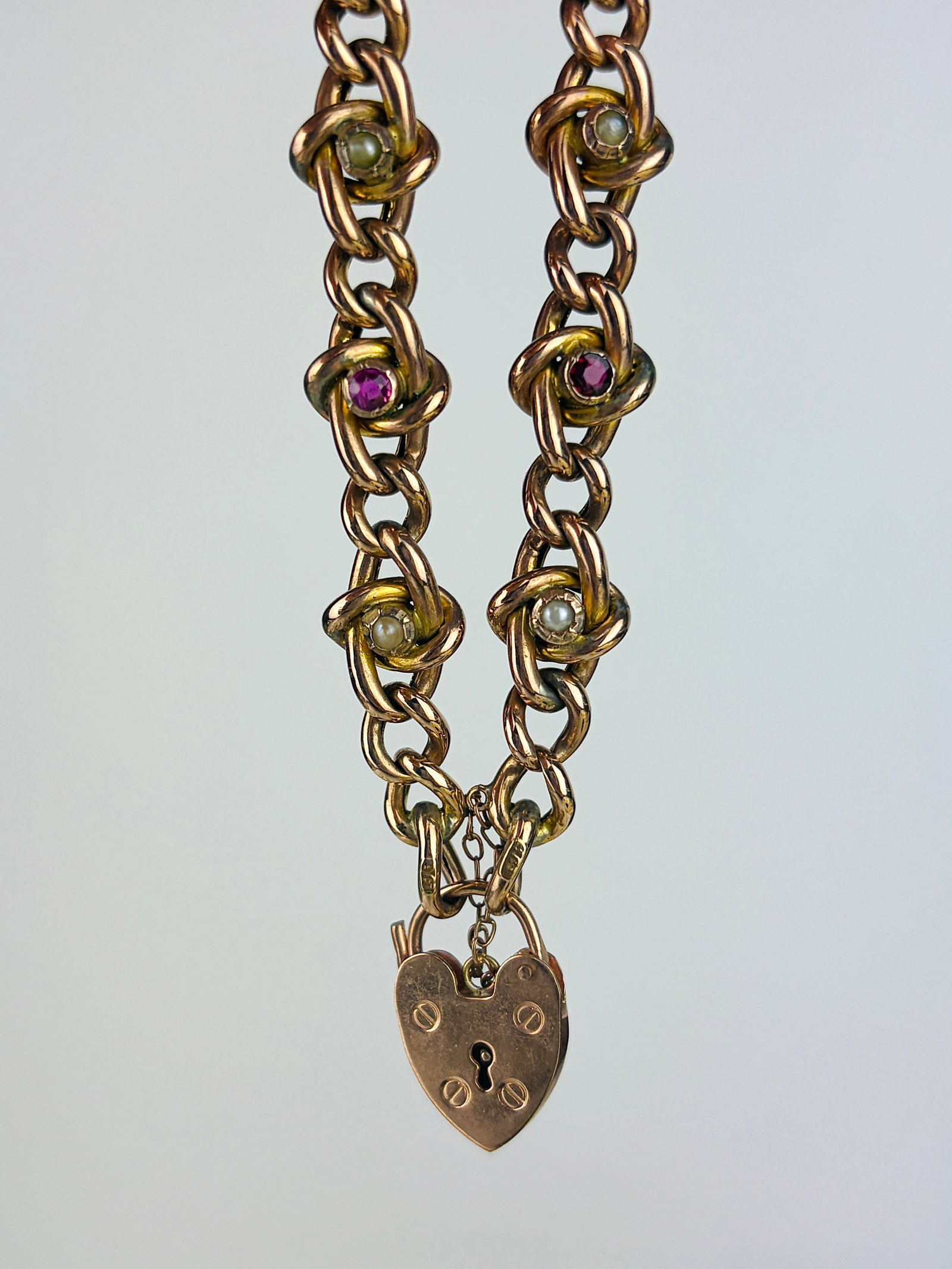 Antique 9ct Gold Stone Set Fancy Link Curb Bracelet with Heart Padlock: Antique 9ct Gold Stone Set Fancy Link Curb Bracelet with Heart Padlock Wonderful bright rubies and sweet pearls! Weight: 13.17g Size: Bracelet length 20cm + 1.3cm padlock, bracelet width 10mm,
