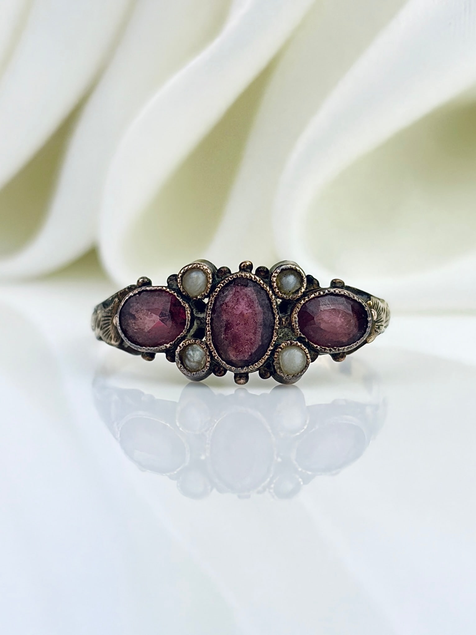ANTIQUE 12CT GOLD AMETHYST AND PEARL ORNATE RING: ANTIQUE 12CT GOLD AMETHYST AND PEARL ORNATE RING Gorgeous unique ring! Weight: 1.37g Size: UK N1/2, US 7.25, Width 7mm, height off finger 2mm Materials: 12ct gold Hallmarks: Faded