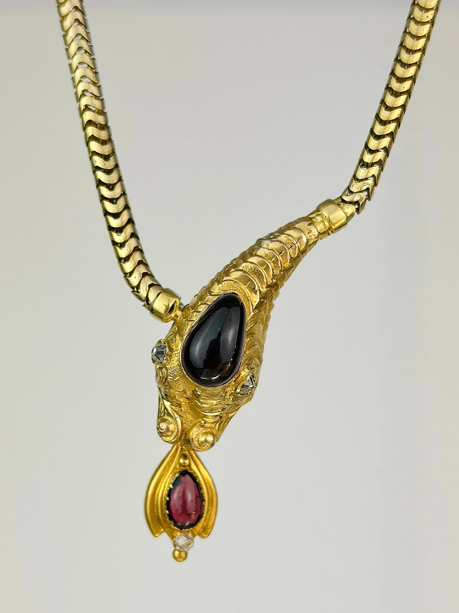 Antique Gold Cabochon Garnet and Diamond Snake Head Necklace: Antique Gold Cabochon Garnet and Diamond Snake Head Necklace Coolest snake necklace that makes a full loop, respelling an ouroboros. The cabochon Garnet stones add so much charm! Weight: