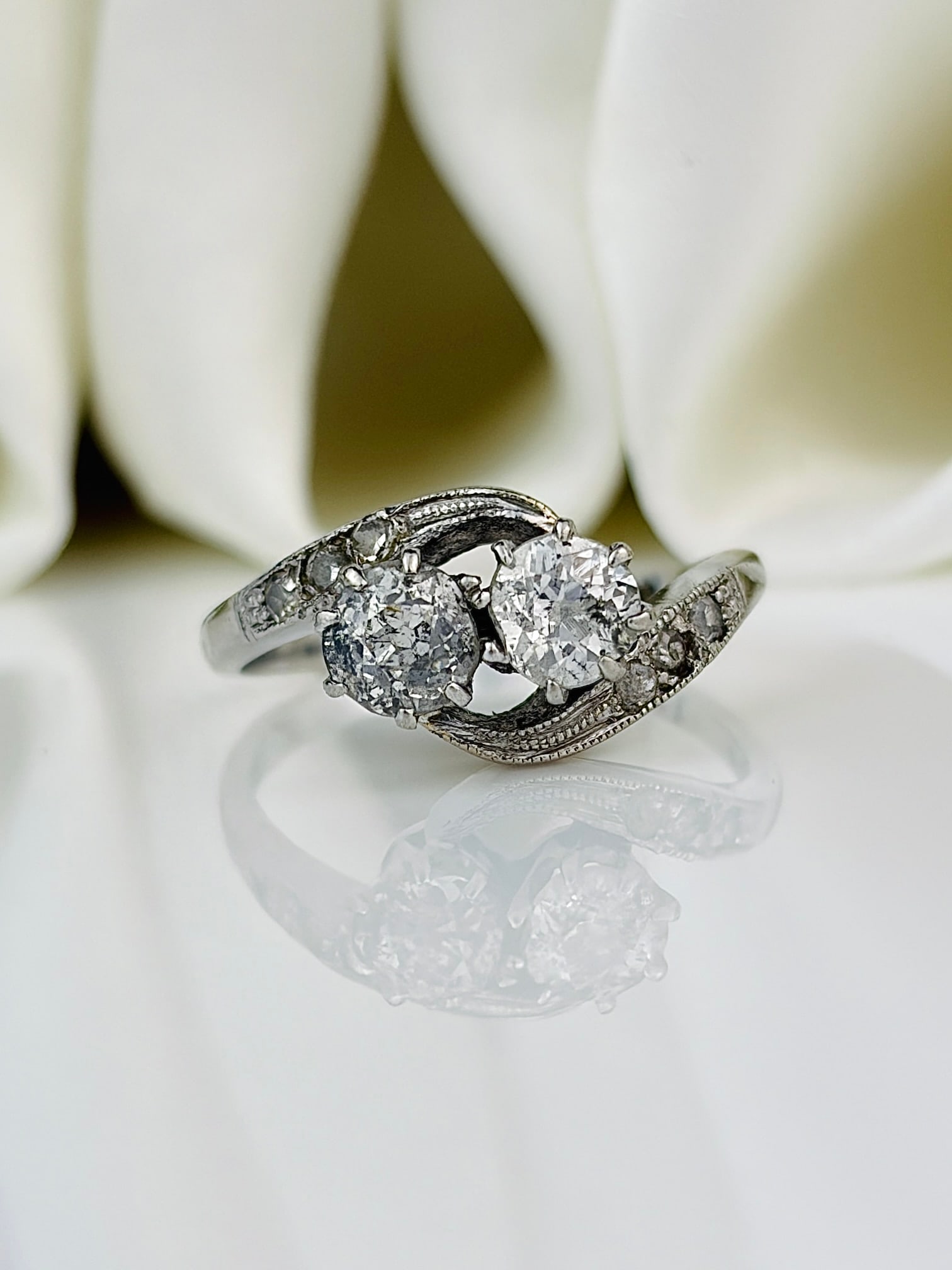 Vintage Diamond 18 Carat White Gold Crossover Moi et Toi Ring: Vintage Diamond 18 Carat White Gold Crossover Moi et Toi Ring This elegant ring features two diamonds each measuring 40pts. The diamond shoulders total 7pts each side. This ring is modelled in 18