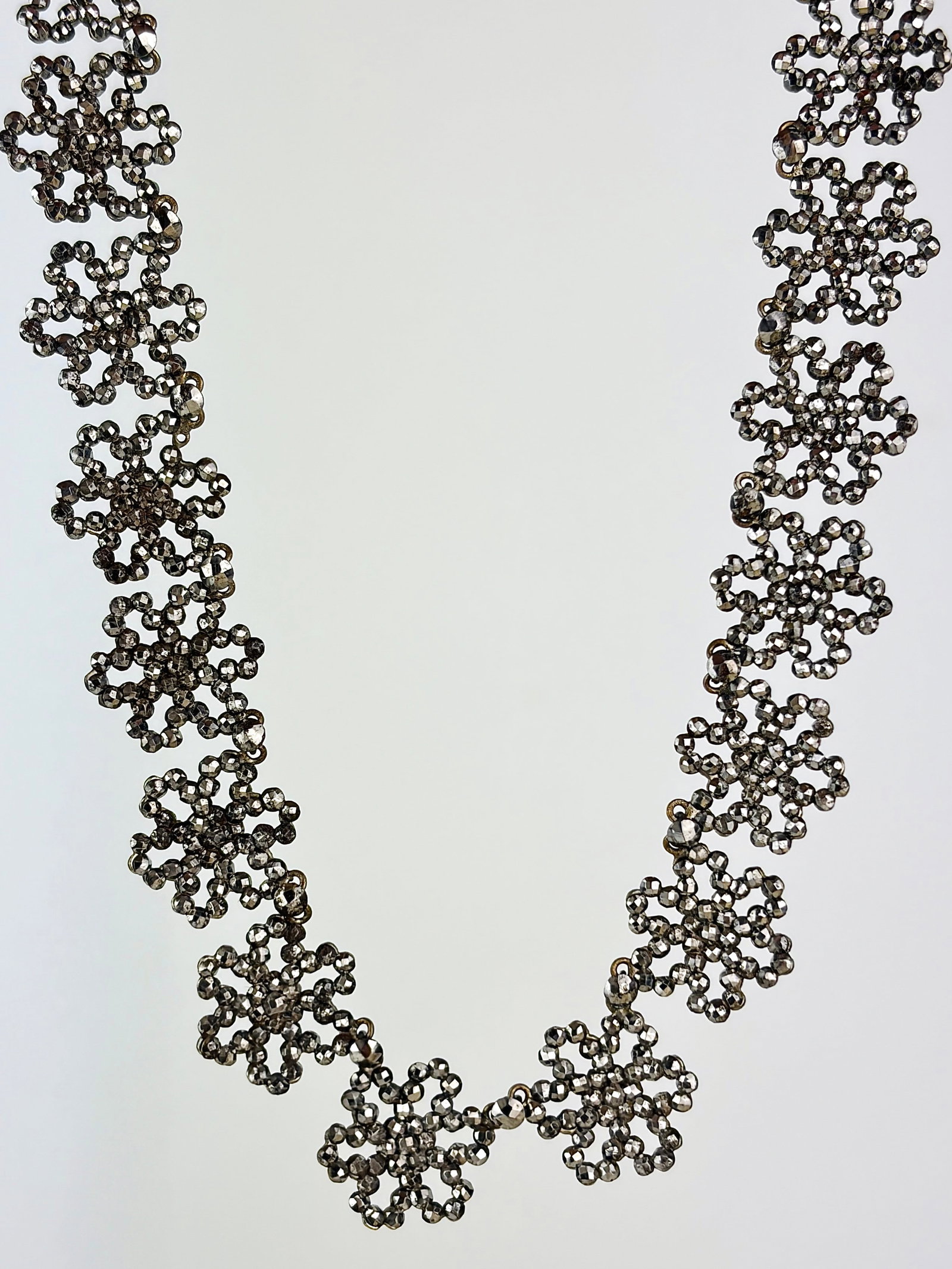 Georgian Era Antique Cut Steel Necklace: georgian era antique cut steel necklace with beautiful flower detailing! Weight: 30.36g Size: Length 35.6cm, width 1.6cm Materials: Cut steel Hallmarks: None present Condition: The