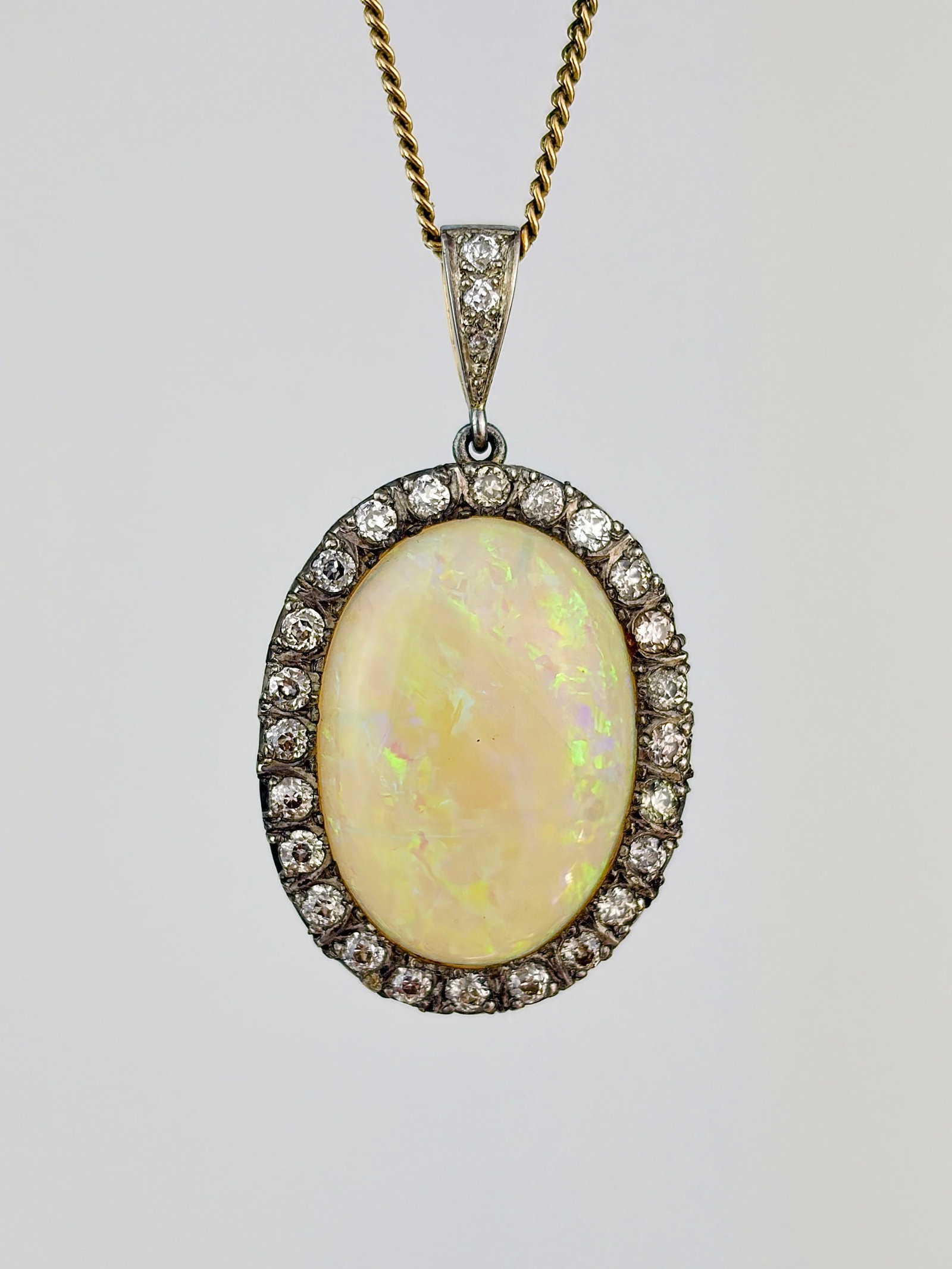 Outstanding Opal and Diamond Large Pendant in Gold: outstanding opal and diamond large opal pendant in gold The most incredible pendant featuring a large candy opal that flashes a new colour with each look, surrounded by a halo of diamonds 