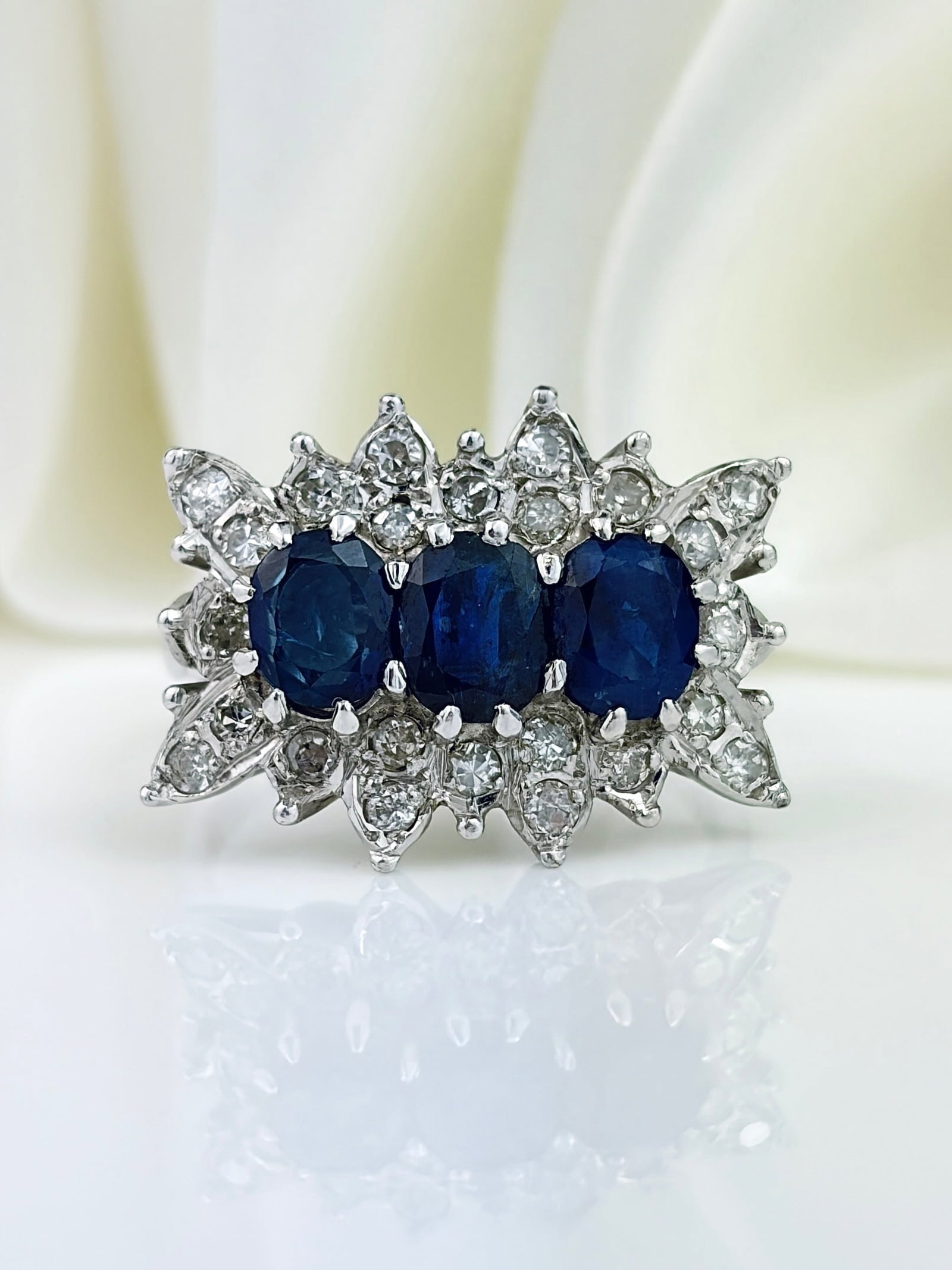 OUTSTANDING VINTAGE 18CT WHITE GOLD C.1976 SAPPHIRE AND DIAMOND TRIPLE CLUSTER RING: OUTSTANDING VINTAGE 18CT WHITE GOLD C.1976 SAPPHIRE AND DIAMOND TRIPLE CLUSTER RING Show stopping triple cluster ring with a unique shaping!