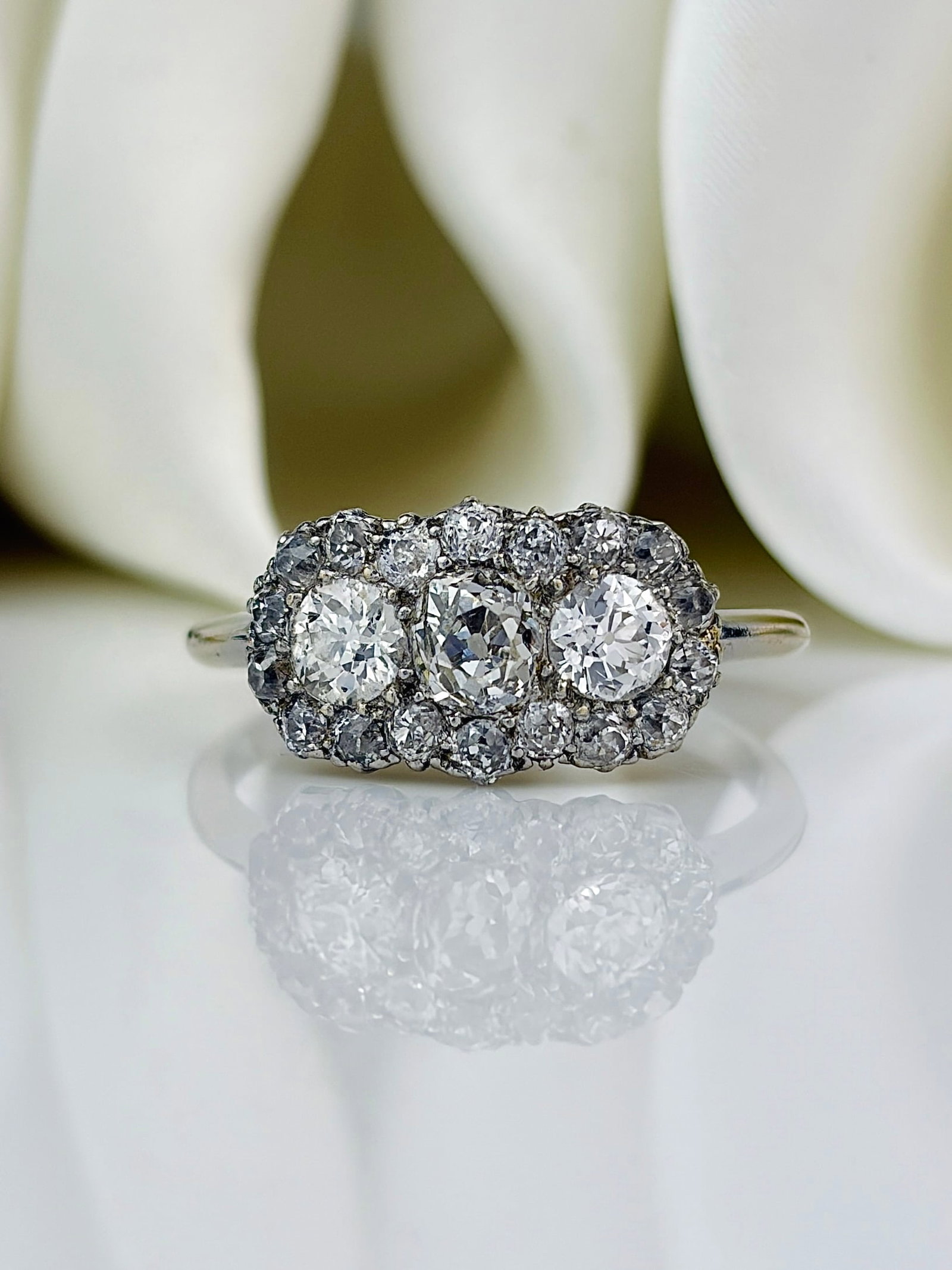 Art Deco 18 Carat White Gold Triple Cluster 1.90ct Diamond Ring: Art Deco 18 Carat White Gold Triple Cluster 1.90ct Diamond Ring This triple cluster diamond ring is super sparkly and holds a total of 1.90 carat. The old mine cut diamonds are set in 18 carat