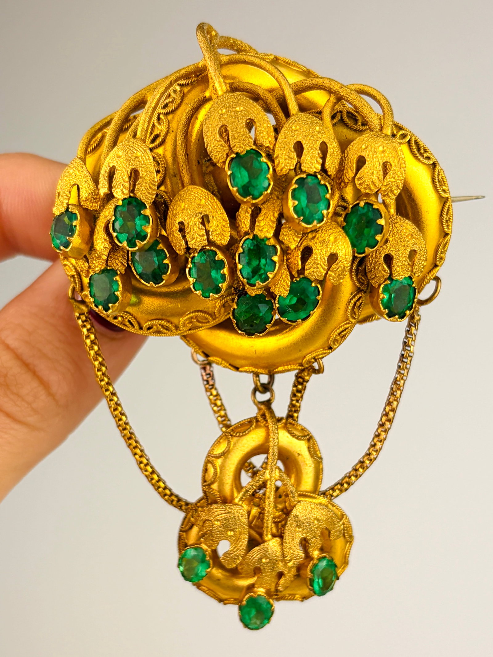 Fancy Extra Large Yellow Metal and Green Paste Brooch: Fancy Extra Large Yellow Metal and Green Paste Brooch Weight: 31.66g Size: 79x50mm, depth 21mm Materials: Yellow Metal Hallmarks: None present Condition: The overall condition is very good