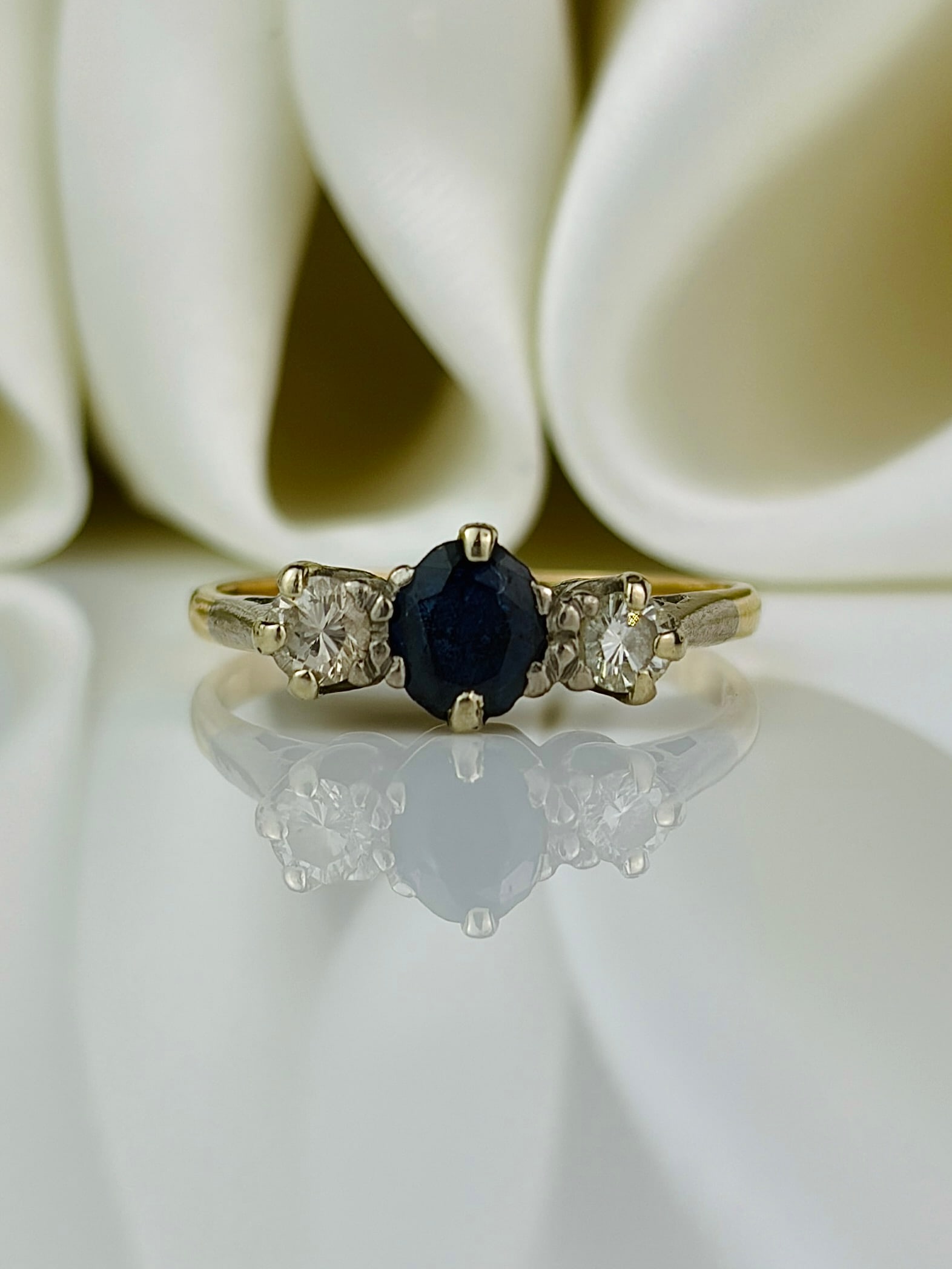 18ct yellow gold sapphire and diamond 3 stone ring: 18ct yellow gold sapphire and diamond 3 stone ring Weight: 2.81g Size: UK N, US 7, Face of ring 5.5x12mm, Height off finger 4.5mm Materials: 18ct yellow gold Hallmarks: Stamped 18ct