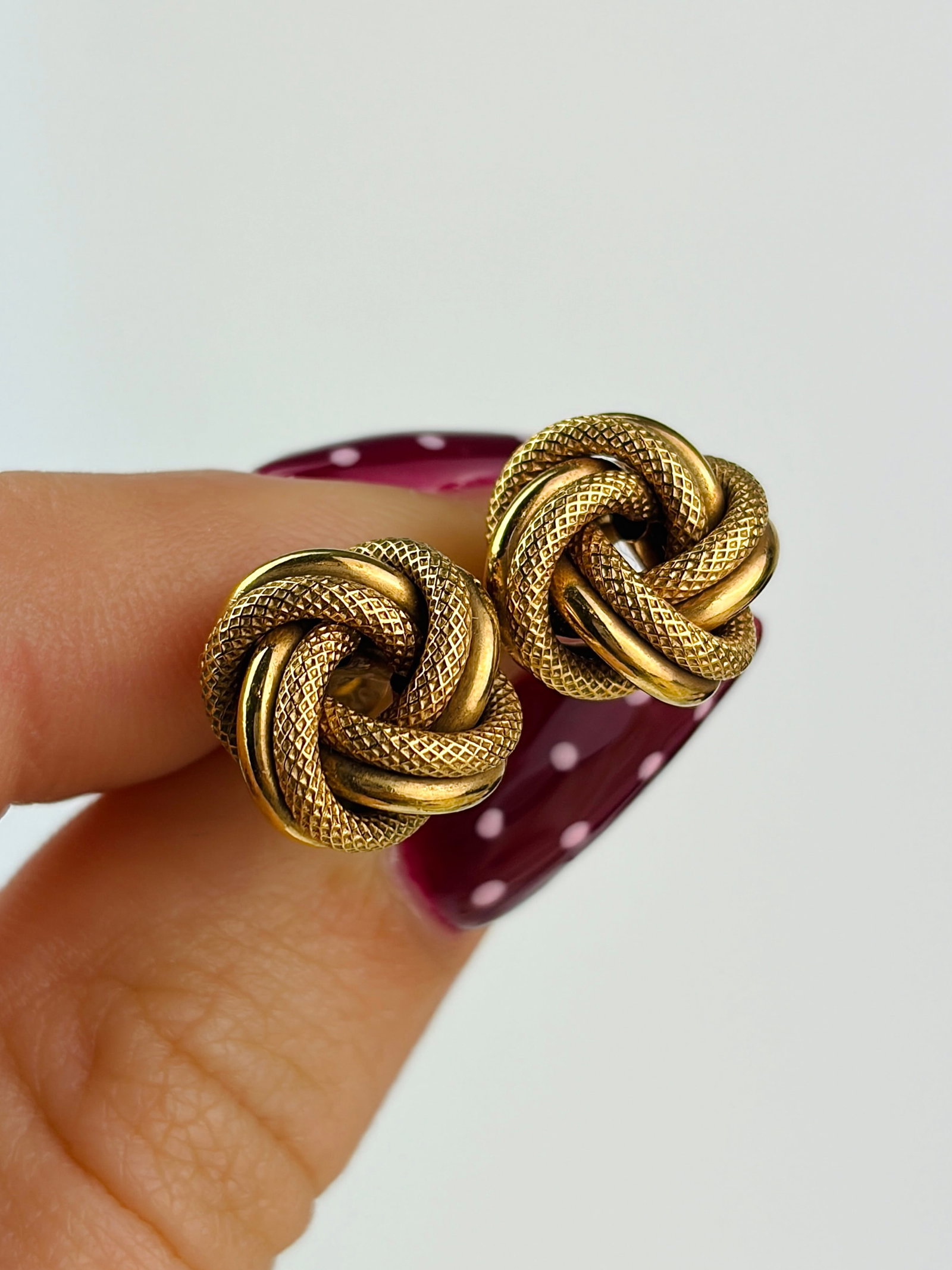 vintage 9ct yellow gold textured knot earrings: vintage 9ct yellow gold textured knot earrings A classic, must have piece! Weight: 1.57g Size: 10x9mm, depth 6mm Materials: 9ct gold Hallmarks: Stamped 375 Condition: Very good overall