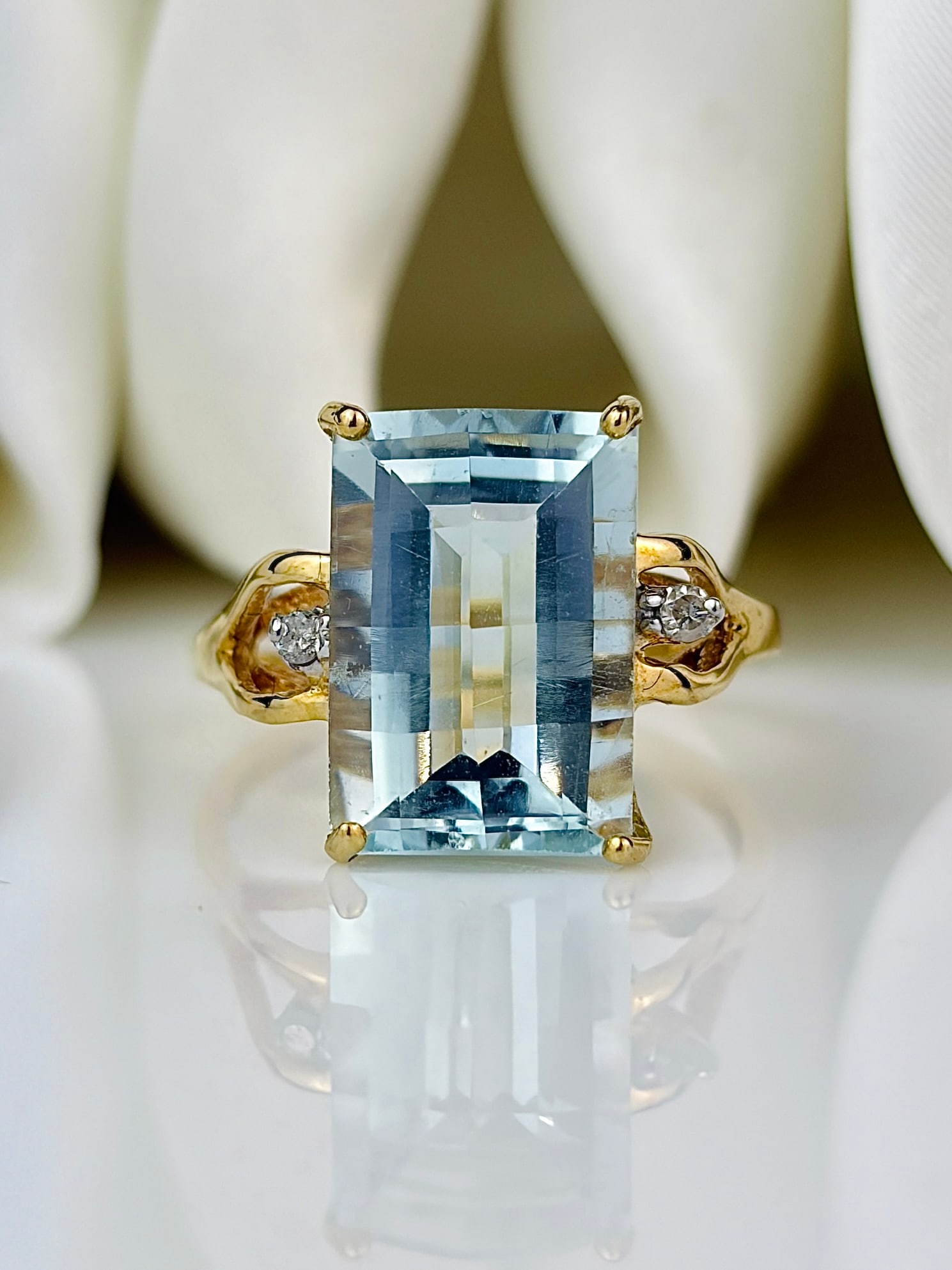 Aquamarine and Diamond 14 Carat Gold Three Stone Ring: Aquamarine and Diamond 14 Carat Gold Three Stone Ring The gorgeous aqua stone in this ring is bright and has a 4pt diamond set either side. The aqua measures approx 6.5carat. The ring is modelled in 1