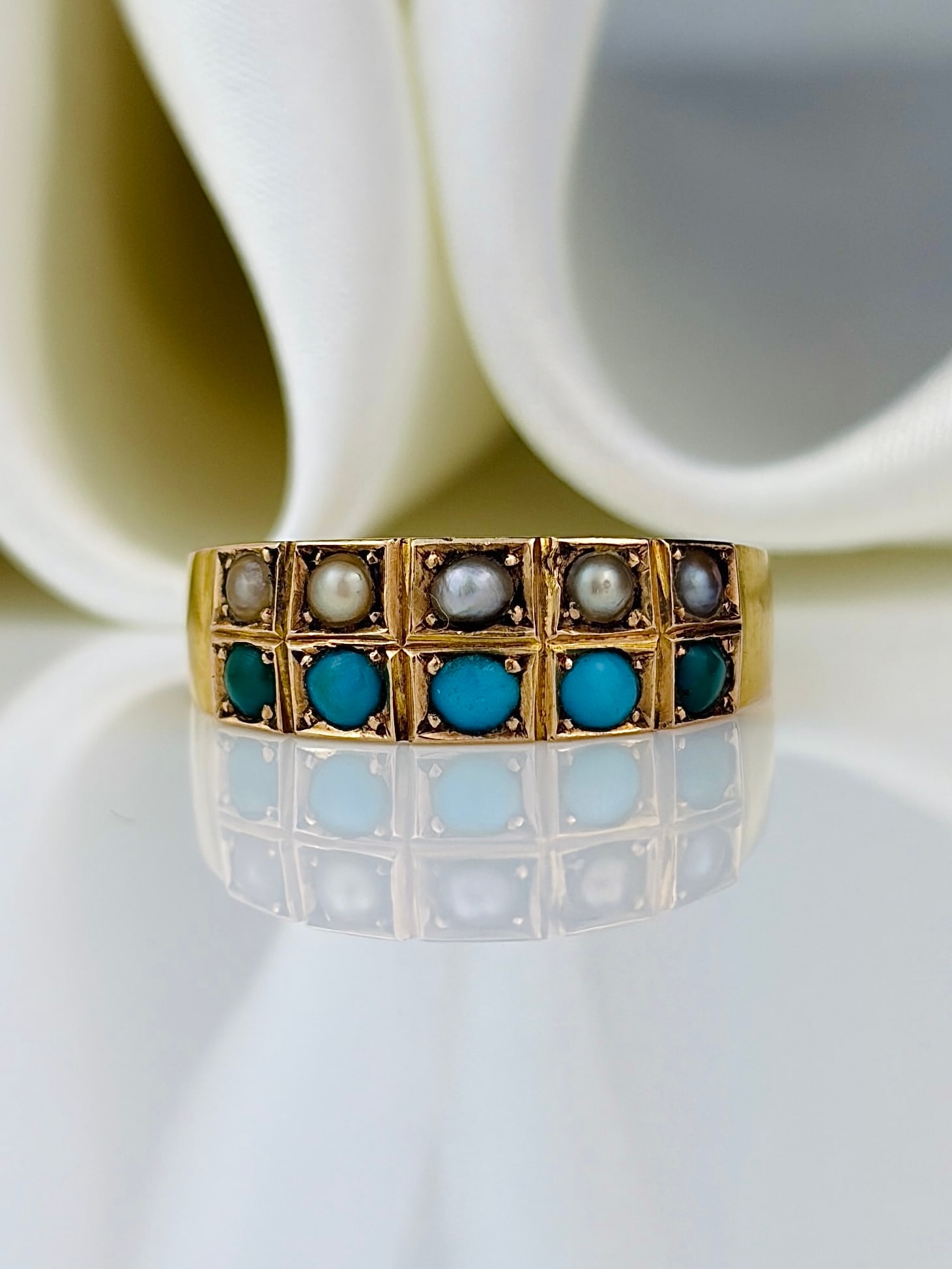 antique c.1881 15ct yellow gold pearl and turquoise two row ring: antique 15ct yellow gold pearl and turquoise two row ring Charming double row gem ring featuring pretty pearls and bright turquoise stones set in a buttery 15ct yellow gold.