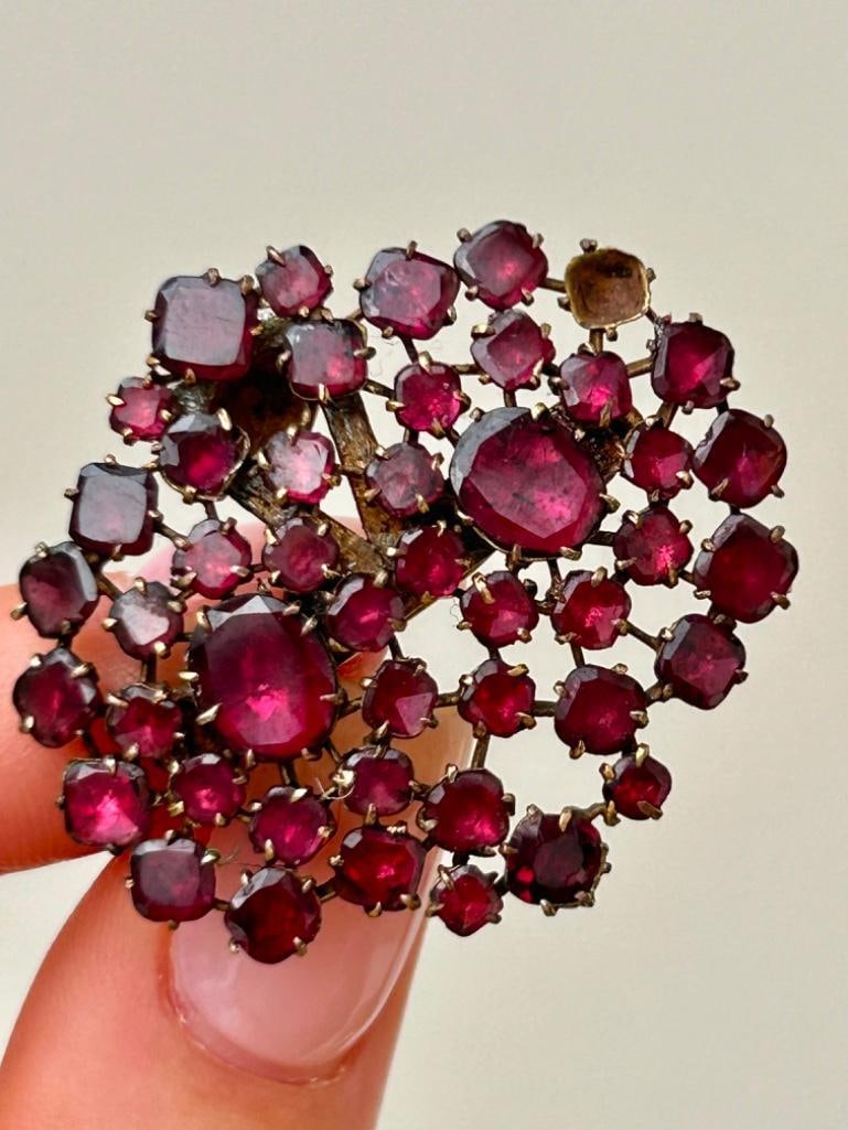 Antique Flat Cut Garnet Large Clip: Antique Flat Cut Garnet Large Clip gorgeous glowing garnet clip! one stone missing measurements size 37mm x 33mm weight 6.43g materials garnet