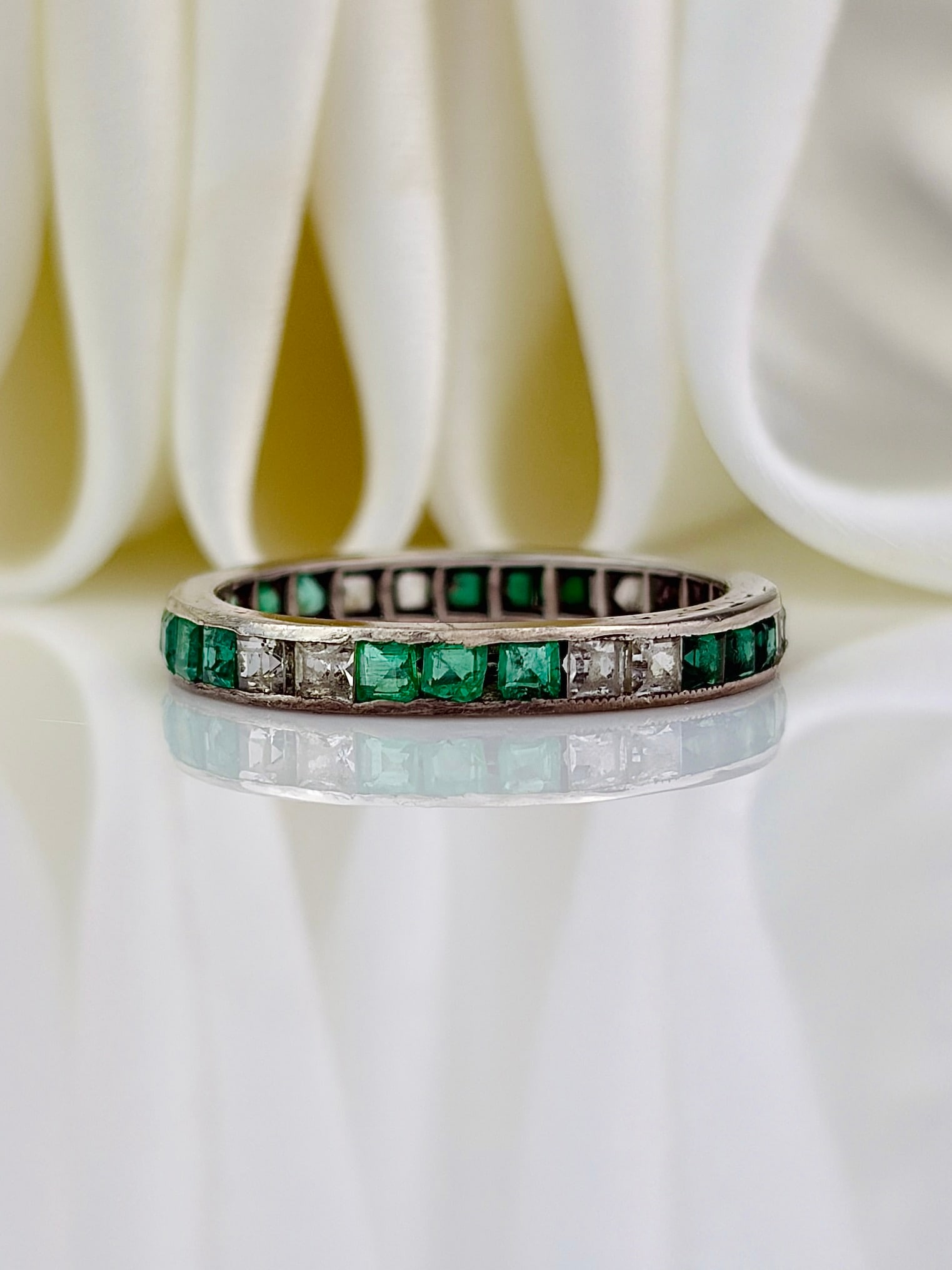 ANTIQUE SILVER EMERALD AND WGITE SAPPHIRE FULL ETERNITY BAND RING: ANTIQUE SILVER EMERALD AND WGITE SAPPHIRE FULL ETERNITY BAND RING Weight: 1.51g Size: UK K1/2, US 5.75, Width 2mm, height off finger 1mm Materials: Silver Hallmarks: None present 