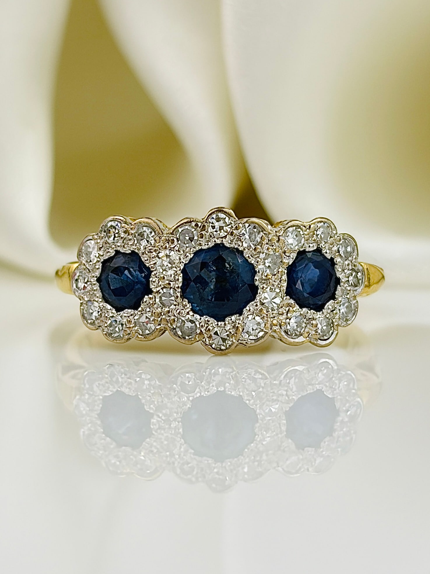 Vintage C.1997 Sapphire and Diamond Triple Cluster Ring in 18ct Yellow Gold: Vintage C.1997 Sapphire and Diamond Triple Cluster Ring in 18ct Yellow Gold Weight: 3.17g Size: UK K1/2, US 5.75, Face of ring 7x17mm, Height off finger 3mm Materials: 18ct gold Hallmarks: London,