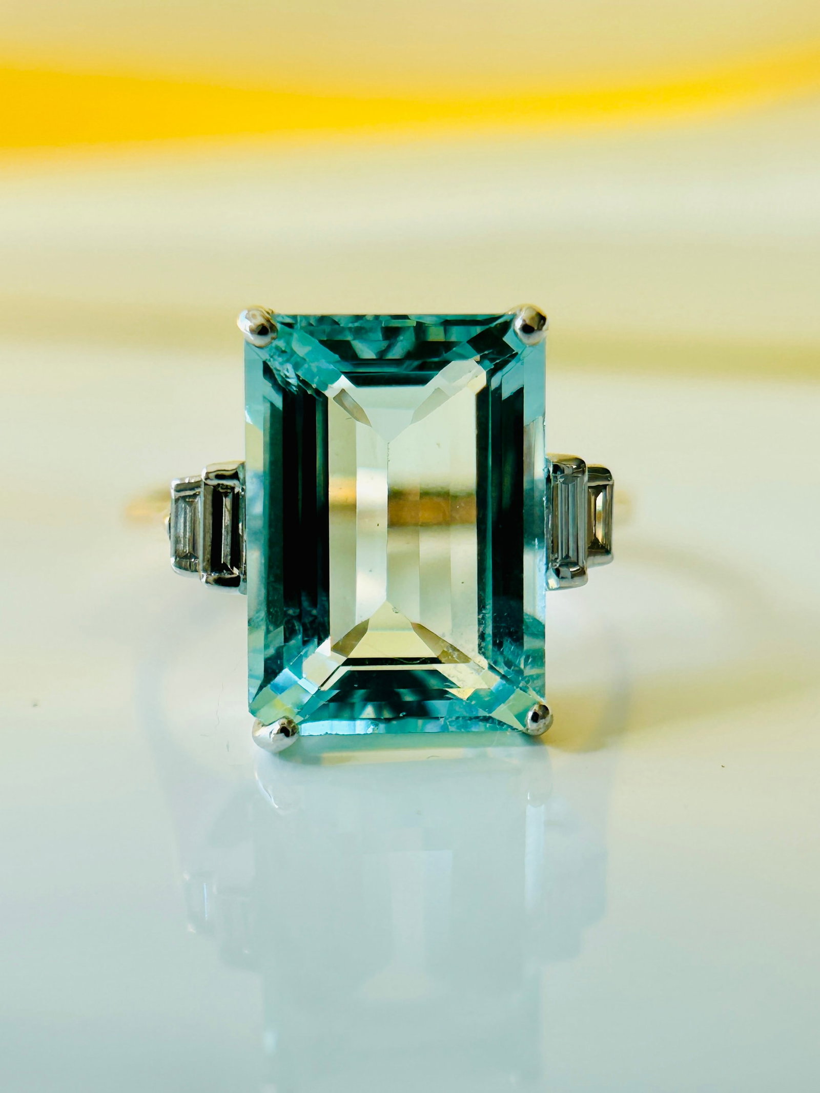 18ct White and Yellow Gold Aquamarine and Baguette Cut Diamond Shoulder Cocktail Ring: 18ct White and Yellow Gold Aquamarine and Baguette Cut Diamond Shoulder Cocktail Ring Weight: 4.17g Size: UK N, US 7 Face of Ring: 13x14mm Height off Finger: 6mm Materials: 18ct gold Hallmarks: