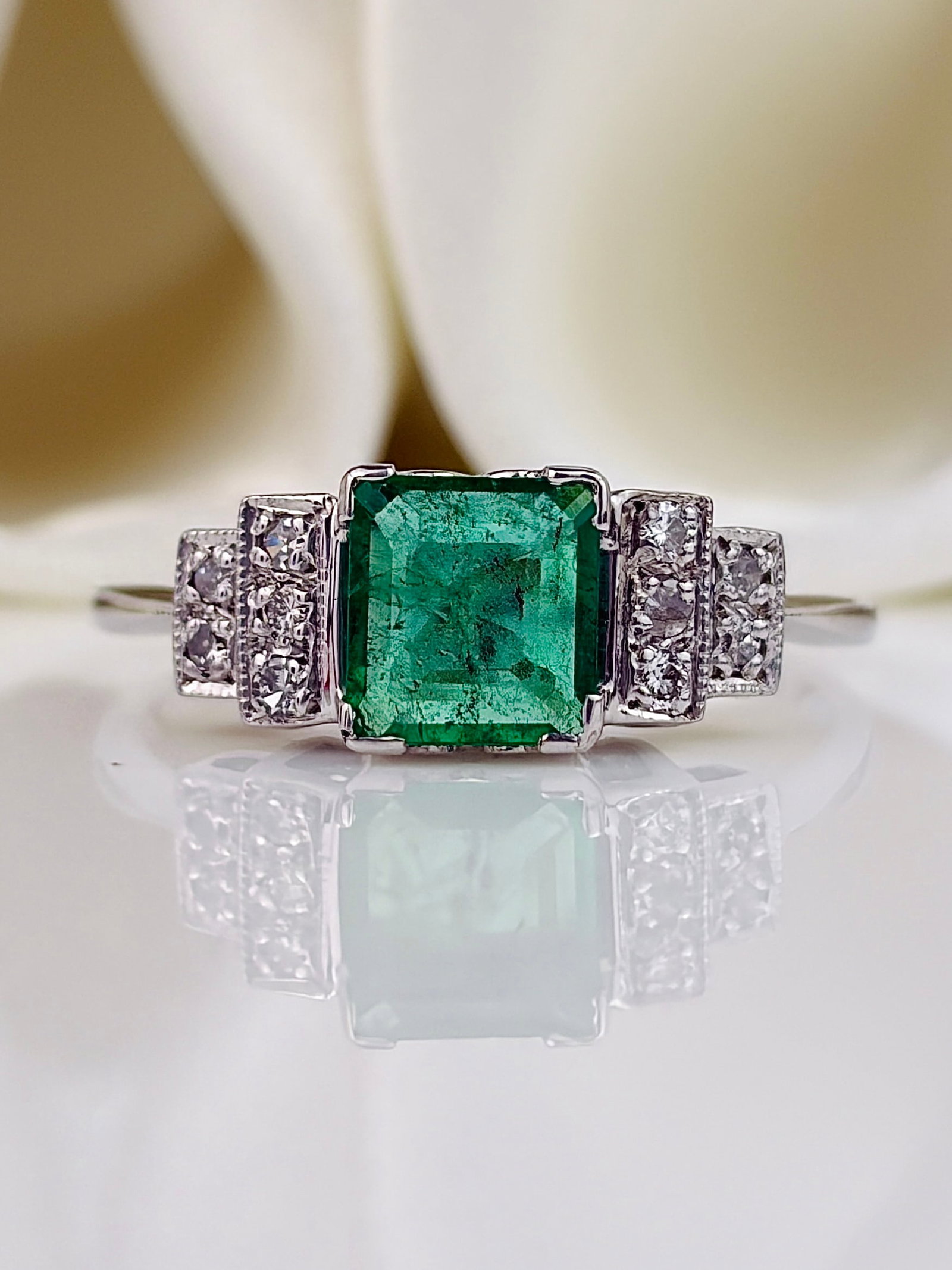 Vintage Platinum Emerald and Diamond Shoulder Ring: Vintage Platinum Emerald and Diamond Shoulder Ring Weight: 3g Size: UK Q, US 8.5, Face of ring 6x14mm, Height off finger 5mm Materials: Platinum Hallmarks: None present Condition: The