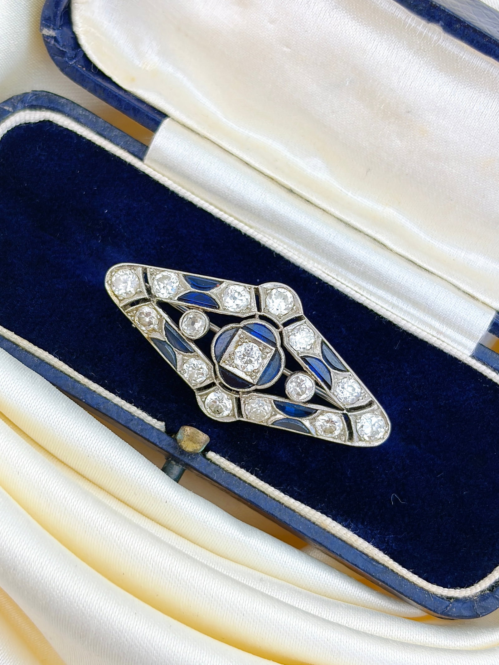 ANTIQUE ART DECO ERA SAPPHIRE AND DIAMOND PLATINUM BROOCH IN ANTIQUE BOX: ANTIQUE ART DECO ERA SAPPHIRE AND DIAMOND PLATINUM BROOCH IN ANTIQUE BOX The most stunning art deco era brooch made with deep blue flat cut sapphires and beautiful round diamonds!