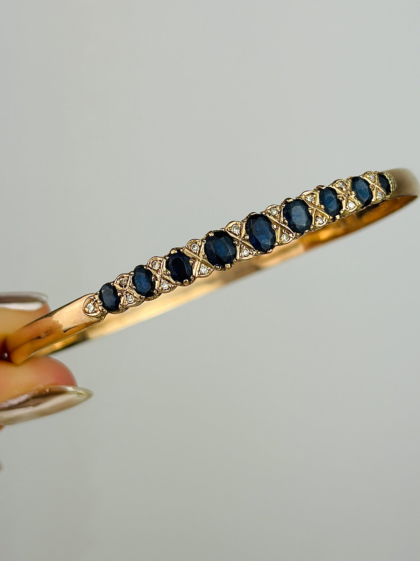 Vintage 9ct Gold Boxed Sapphire and Diamond Bangle Bracelet: Vintage 9ct Gold Boxed Sapphire and Diamond Bangle Bracelet Weight: 11.24g Size: Inner circumference 20cm, Width 5mm Materials: 9ct gold Hallmarks: stamped 9ct Condition: The overall condition is