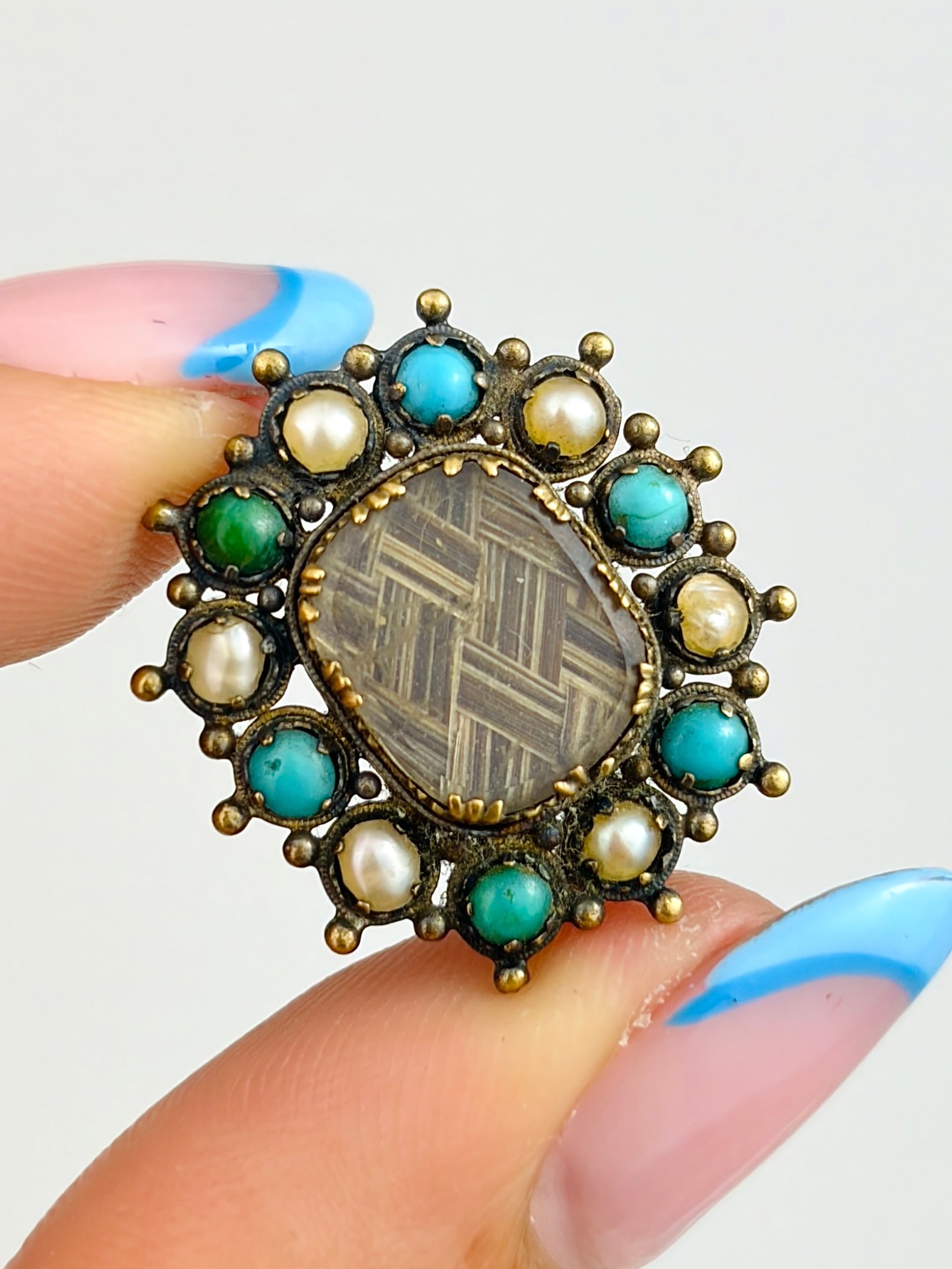 ANTIQUE GOLD TURQUOISE AND PEARL LOCKET FRONT BROOCH AF: ANTIQUE GOLD TURQUOISE AND PEARL LOCKET FRONT BROOCH AF A gorgeous brooch with pretty pearls and turquoise stones surrounding a central locket with blonde and brunette hairs braided together!