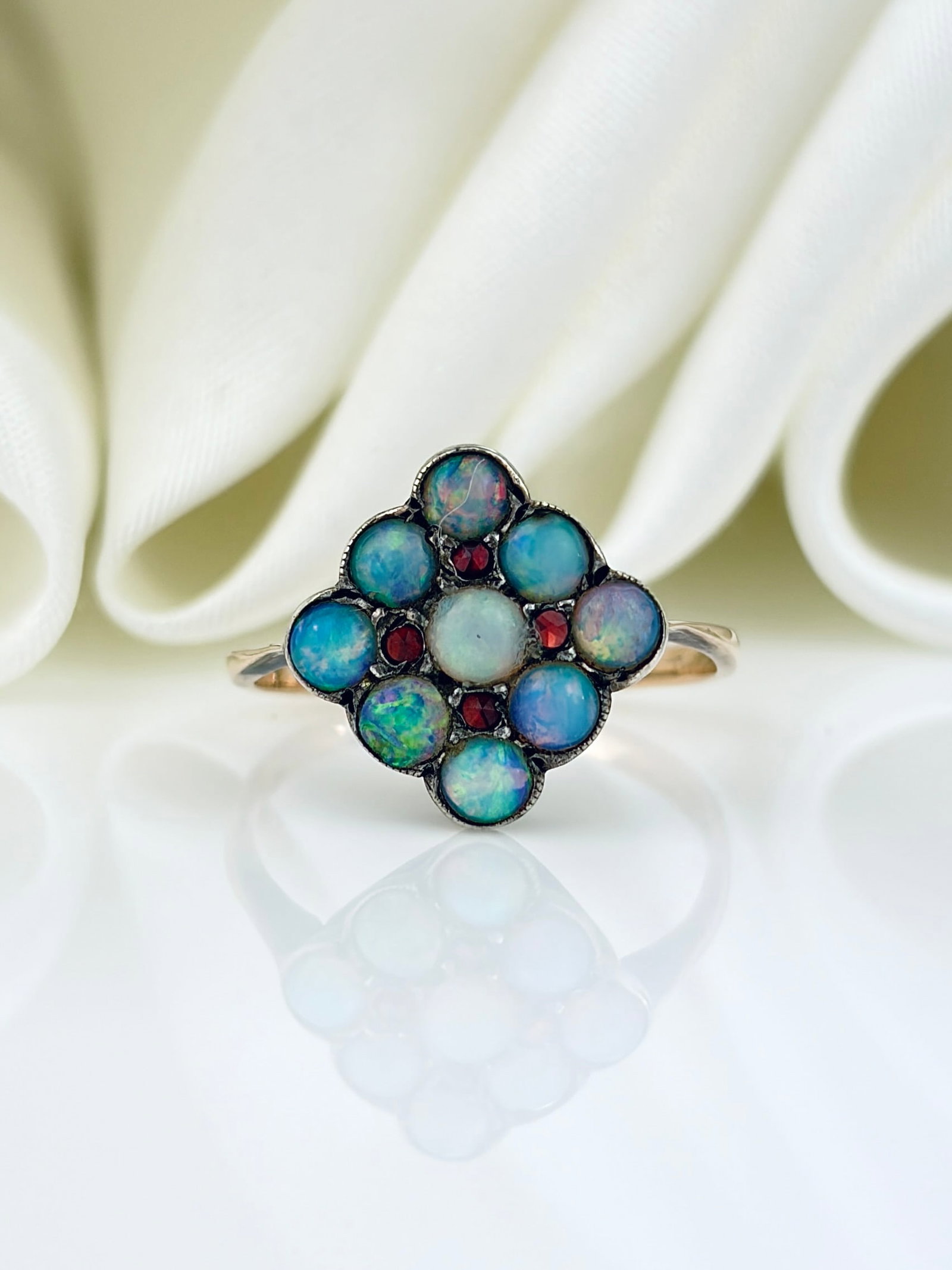 ANTIQUE OPAL AND GARNET CLUSTER RING IN GOLD AND SILVER: ANTIQUE OPAL AND GARNET CLUSTER RING IN GOLD AND SILVER The band is gold, but stones are set in silver. 