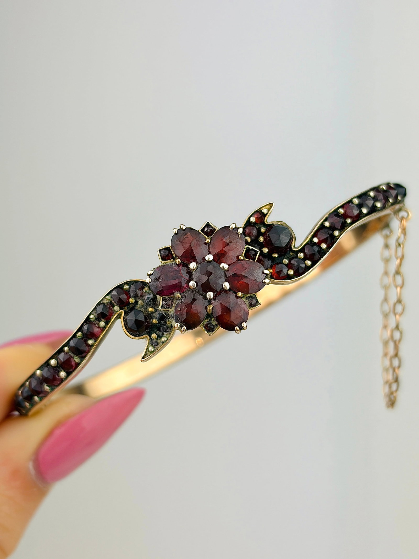 ANTIQUE GARNET BANGLE / BRACELET: ANTIQUE GARNET BANGLE / BRACELET Lovely flower design garnet bangle, with safety chain