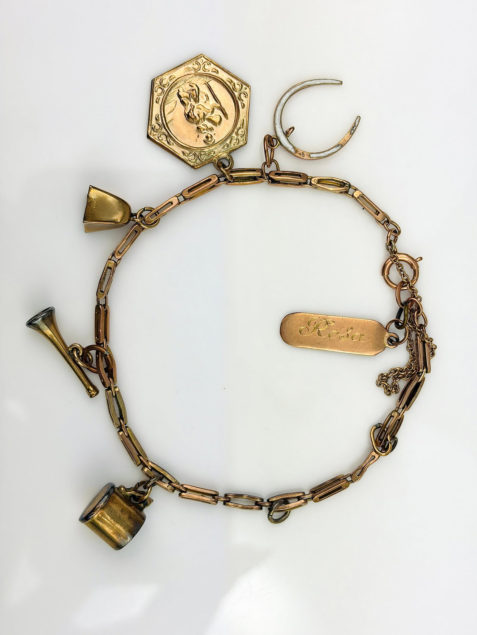 VINTAGE 9CT YELLOW GOLD CHARM BRACELET WITH ENAMEL HORSESHOE, ST. CHRISTOPHER ETC: VINTAGE 9CT YELLOW GOLD CHARM BRACELET WITH ENAMEL HORSESHOE, ST. CHRISTOPHER ETC with safety chain