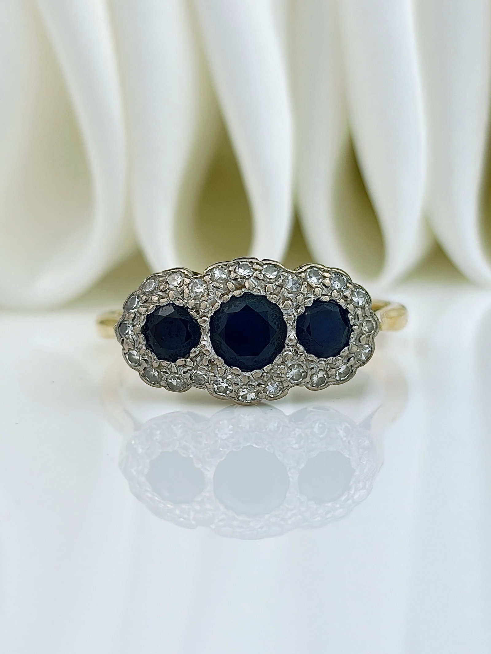 CHUNKY 18ct GOLD SAPPHIRE AND DIAMOND TRIPLE CLUSTER RING: CHUNKY 18ct GOLD SAPPHIRE AND DIAMOND TRIPLE CLUSTER RING Such a charming cluster ring! Weight: 4.3g Size: UK V, US 10.5, Width 9mm, height off finger 4mm Materials: 18ct gold, diamond, sapphire