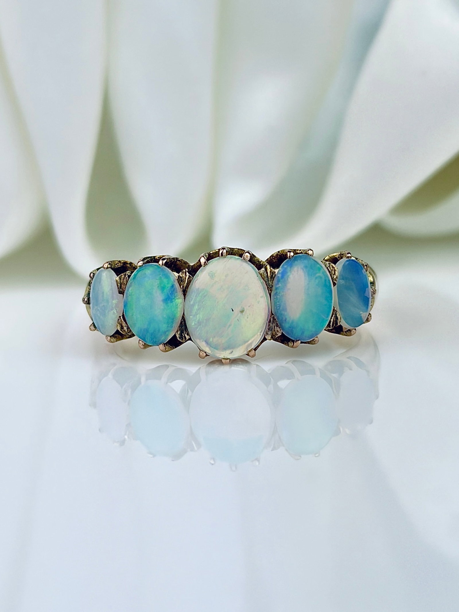 VINTAGE OPAL 5 STONE RING IN GOLD: VINTAGE OPAL 5 STONE RING IN GOLD Such bright stones! Weight: 3.66g Size: UK O1/2, US 7.75, Width 7mm, height off finger 4mm Materials: Gold Hallmarks: None present Condition: Very