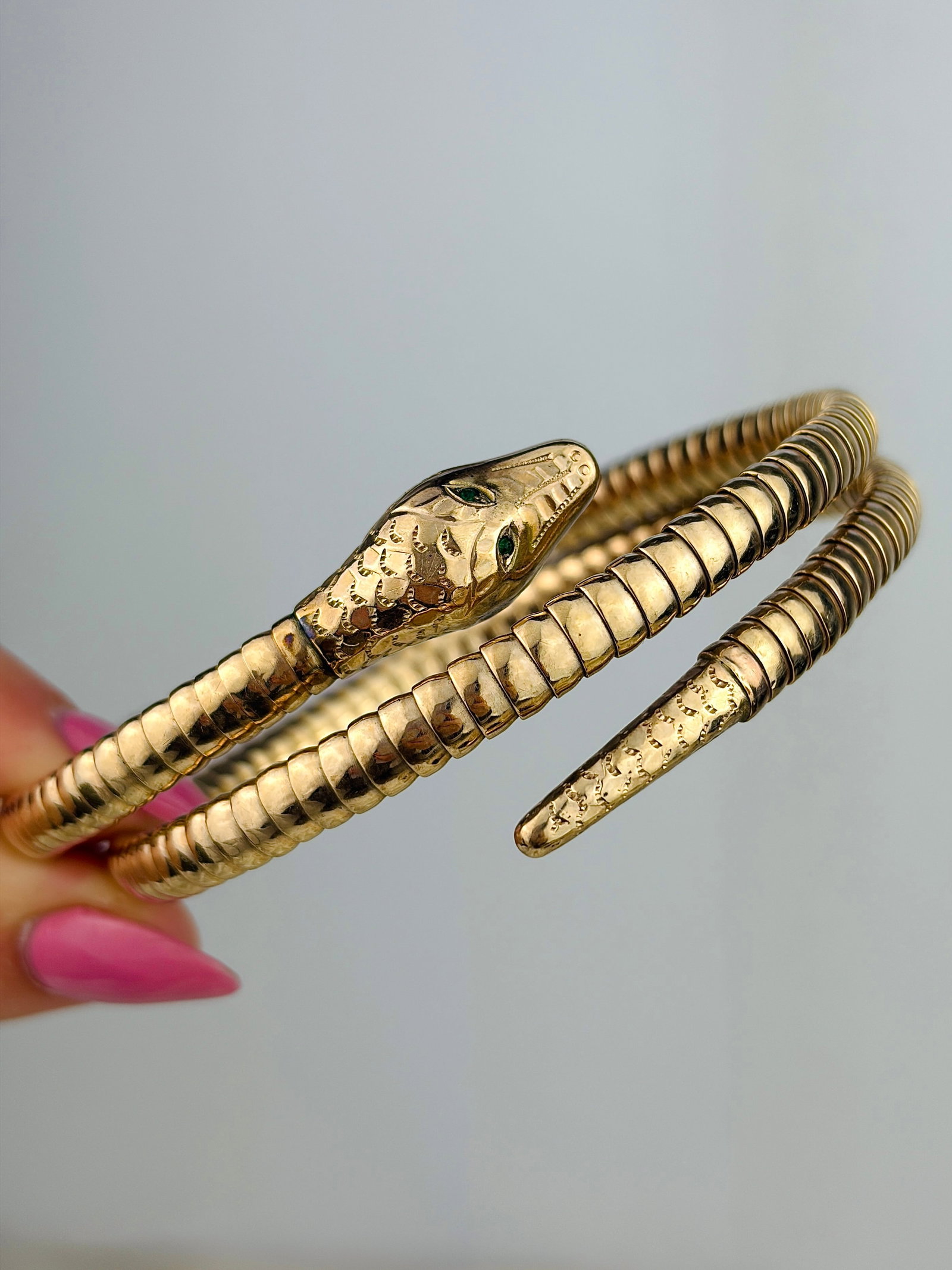 VINTAGE 9ct GOLD COILED SNAKE BANGLE / BRACELET: VINTAGE 9ct GOLD COILED SNAKE BANGLE / BRACELET Stunning vintage coiled snake bangle with striking green eyes! A flexible wrap around design. Weight: 22.75g Size: Inner circumference when