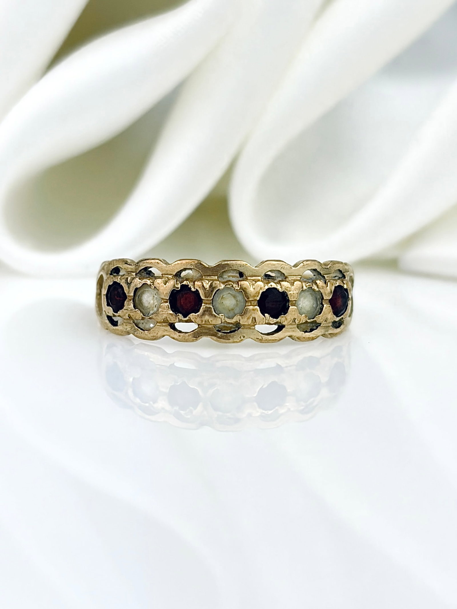 Vintage 9ct Yellow Gold Garnet and White Stone Half Hoop Ring: Vintage 9ct Yellow Gold Garnet and White Stone Half Hoop Ring Stunning ring with scalloped edge! Weight: 1.65g Size: UK M, US 6.5, width 6mm, height off finger 2mm Materials: 9ct gold, garnet, white