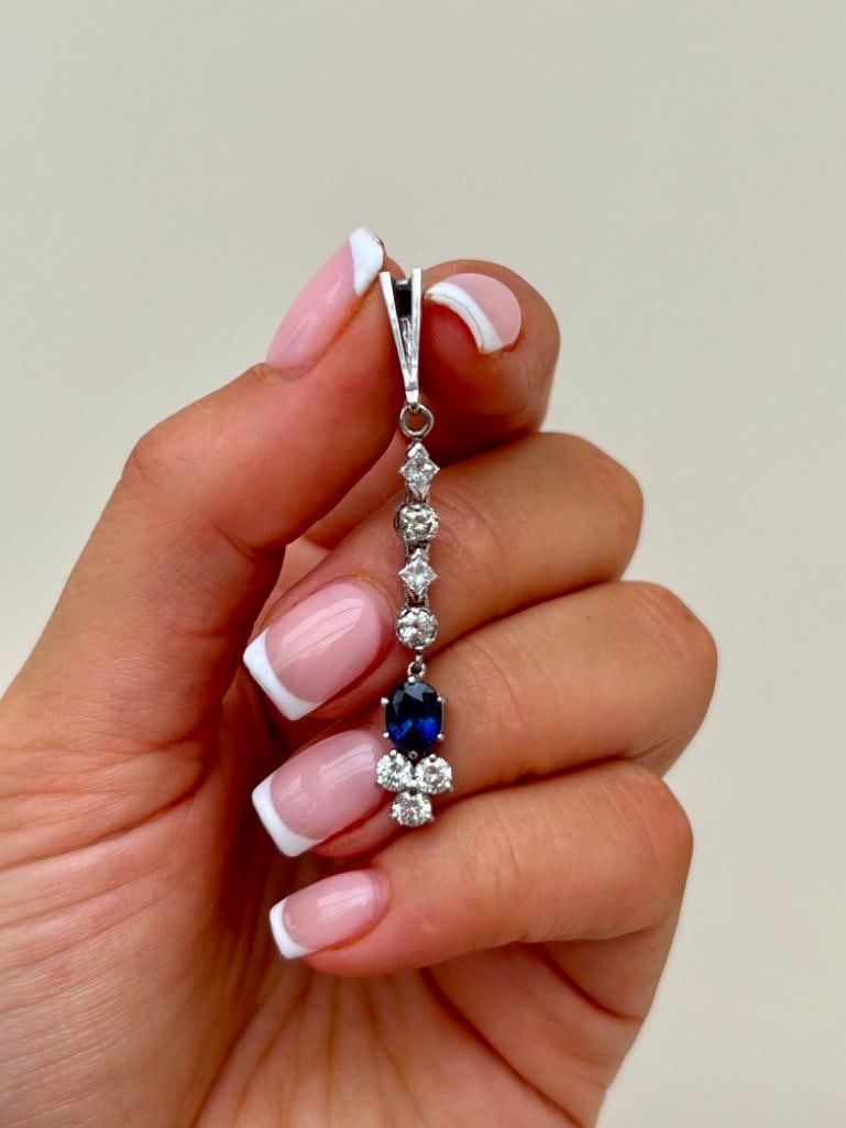 White Gold Diamond and Sapphire Drop Pendant: White Gold Diamond and Sapphire Drop Pendant chain for display purposes only. the most exquisite and elegant pendant! measurements size 50mm x 6mm weigh