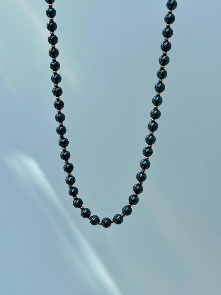 9ct Gold Haemetite Haitian Pearl Gold Spacer Necklace: 9ct Gold Haemetite Haitian Pearl Gold Spacer Necklace beautiful pearl necklace measurements length 59cm width 5mm weight 45.65g materials 9ct gold and