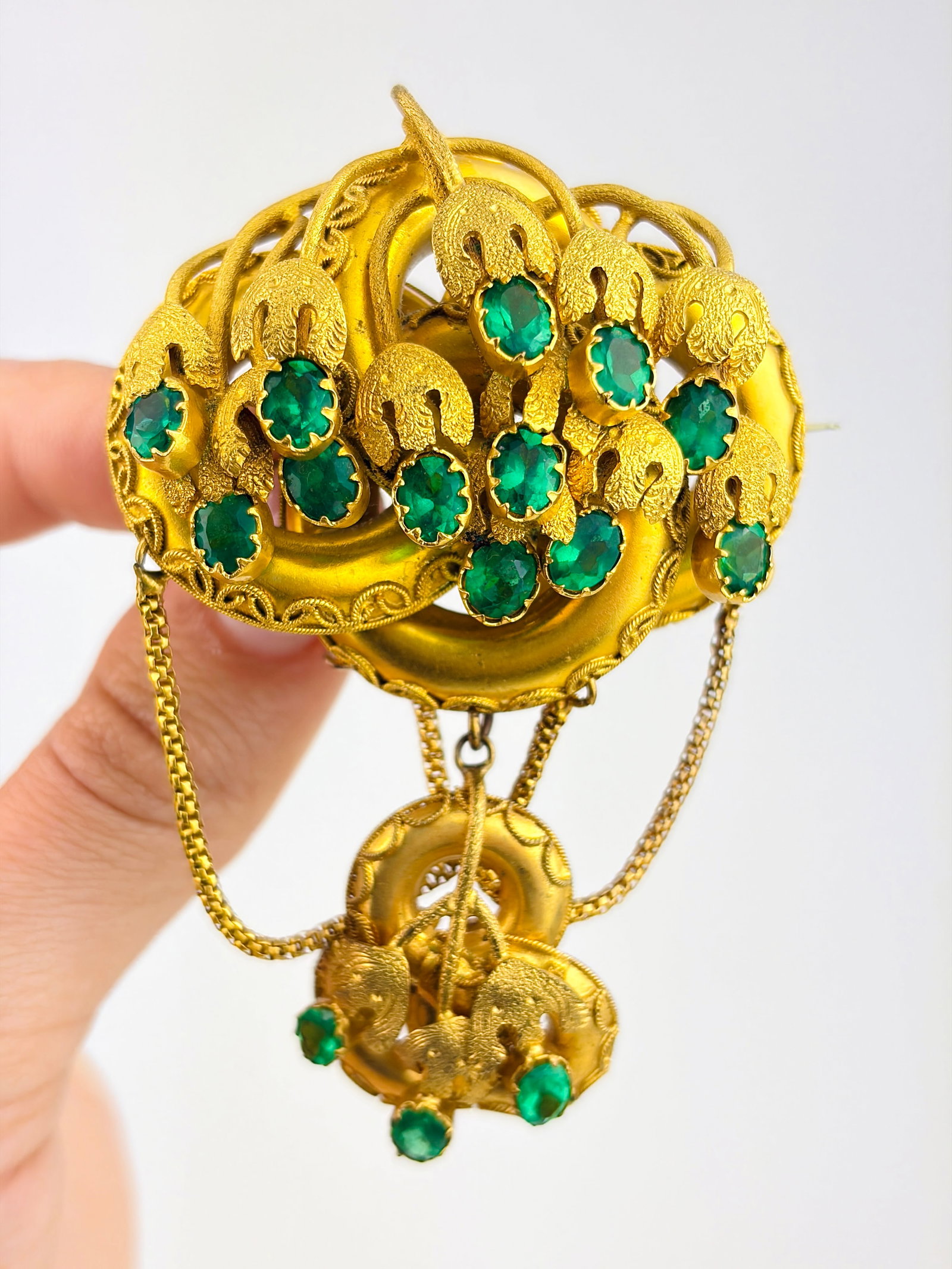 Fancy Extra Large Yellow Metal and Green Paste Brooch: Fancy Extra Large Yellow Metal and Green Paste Brooch Weight: 31.66g Size: 79x50mm, depth 21mm Materials: Yellow Metal Hallmarks: None present Condition: The overall condition is very good