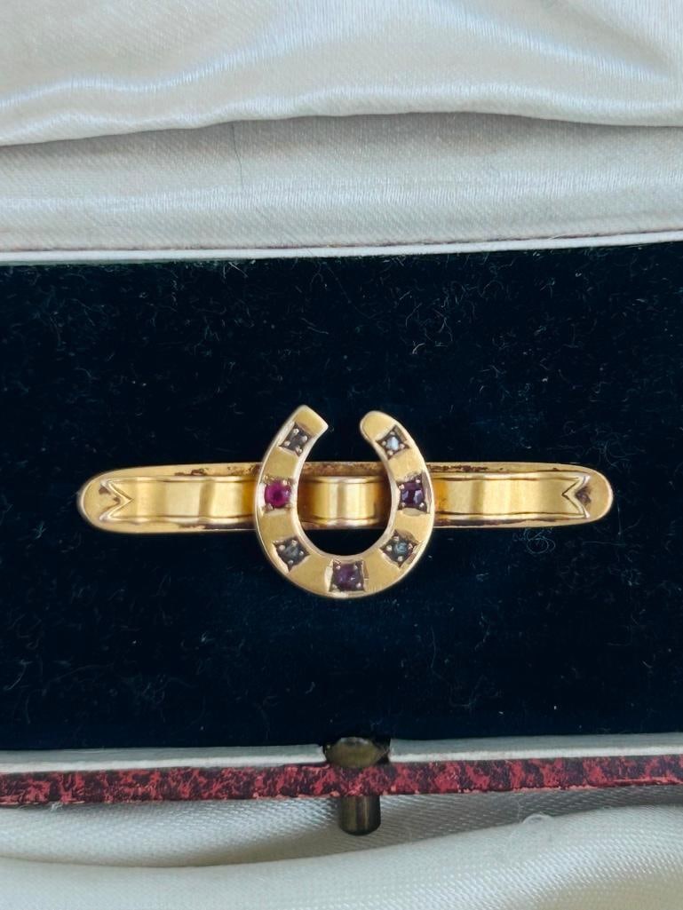 Antique 18ct Yellow Gold Ruby and Diamond Horseshoe Brooch in Antique Box: Antique 18ct Yellow Gold Ruby and Diamond Horseshoe Brooch in Antique Box truly charming and sweet! measurements size 36mm x 13mm weight 2.67g materials