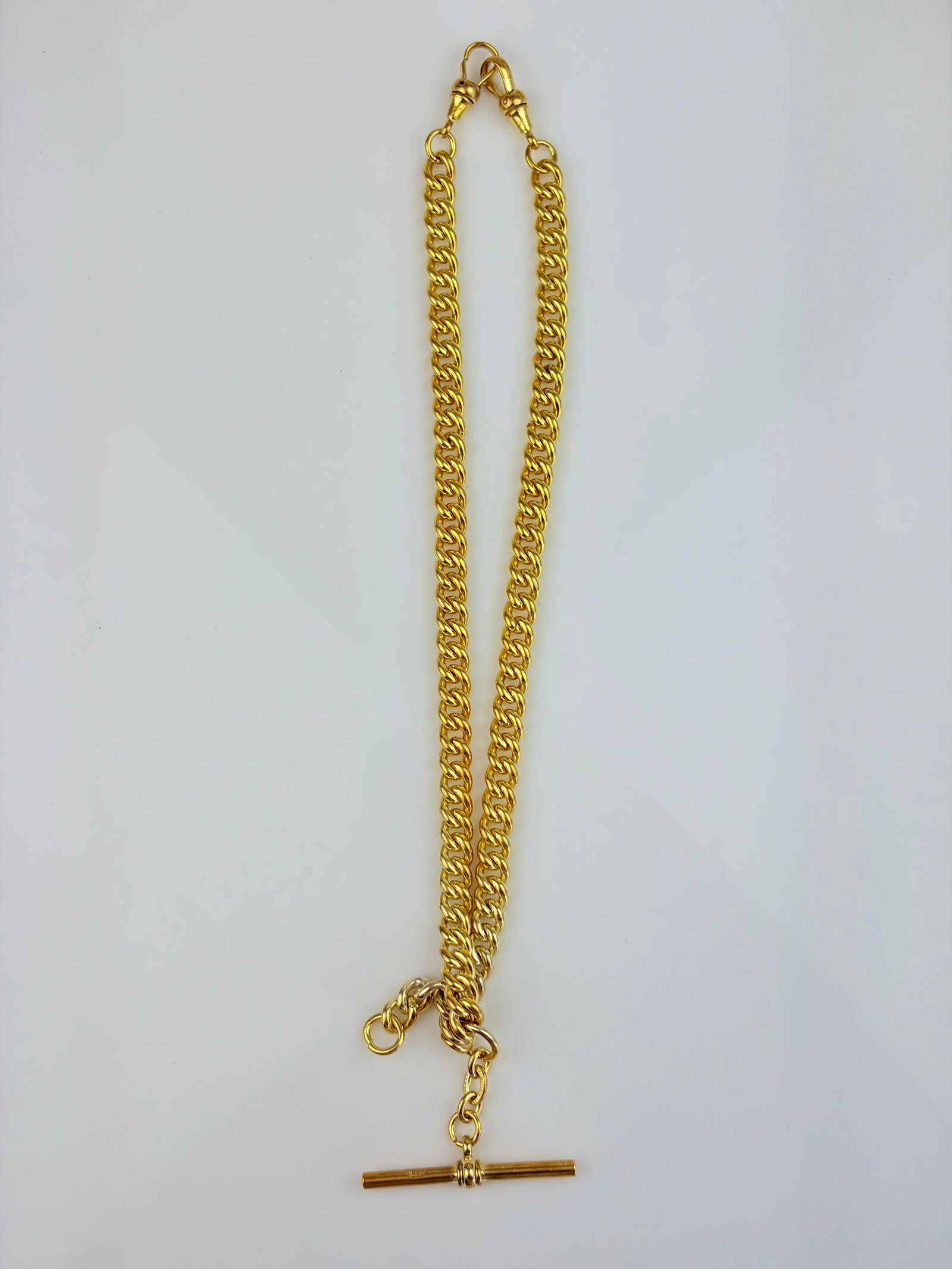 Yellow Metal Double Albert Chain with Tbar: Yellow Metal Double Albert Chain with Tbar Weight 42.24g Length 39cm
