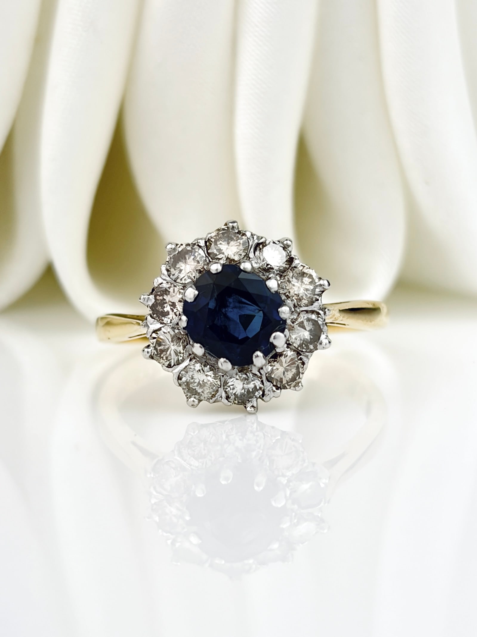 Art Deco Sapphire and Diamond 18 Carat and Platinum Cluster Ring: Art Deco Sapphire and Diamond 18 Carat and Platinum Cluster Ring The sapphire is a deep blue colour and measures Icarat and the diamonds total approximately 70pts. Fully hallmarked