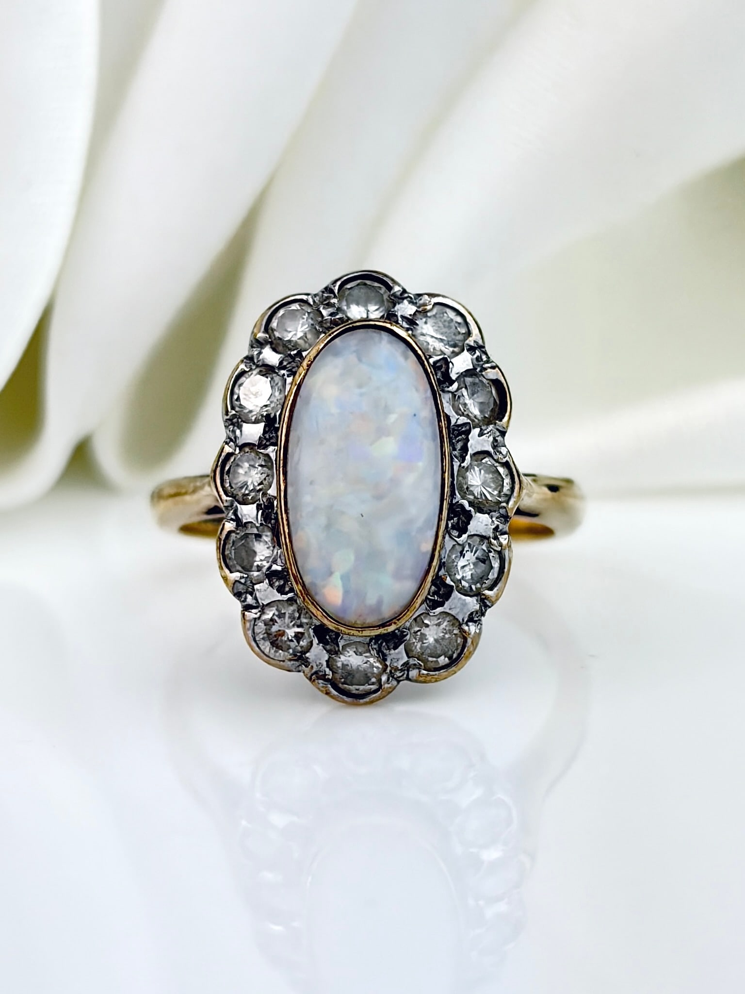 Outstanding Opal And Diamond Oval Ring in Yellow Gold: Outstanding Opal And Diamond Oval Ring in 9ct Yellow Gold A striking, beautiful opal surrounded by the sparkliest of diamonds!