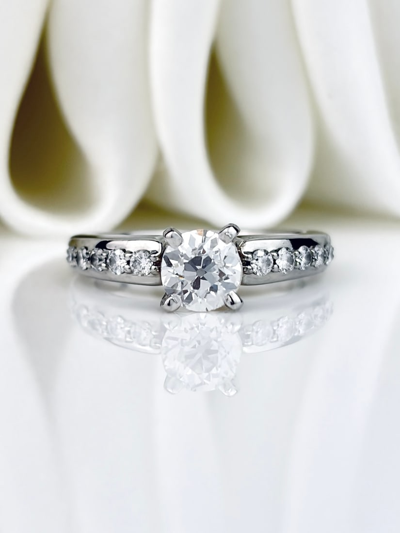 *Vintage Diamond and Platinum Solitaire Ring: Vintage Diamond and Platinum Solitaire Ring The main diamond in this ring measures 60pts and is H/I onlour. The stone has a wonderful glisten to it and either side sit five graduated dia
