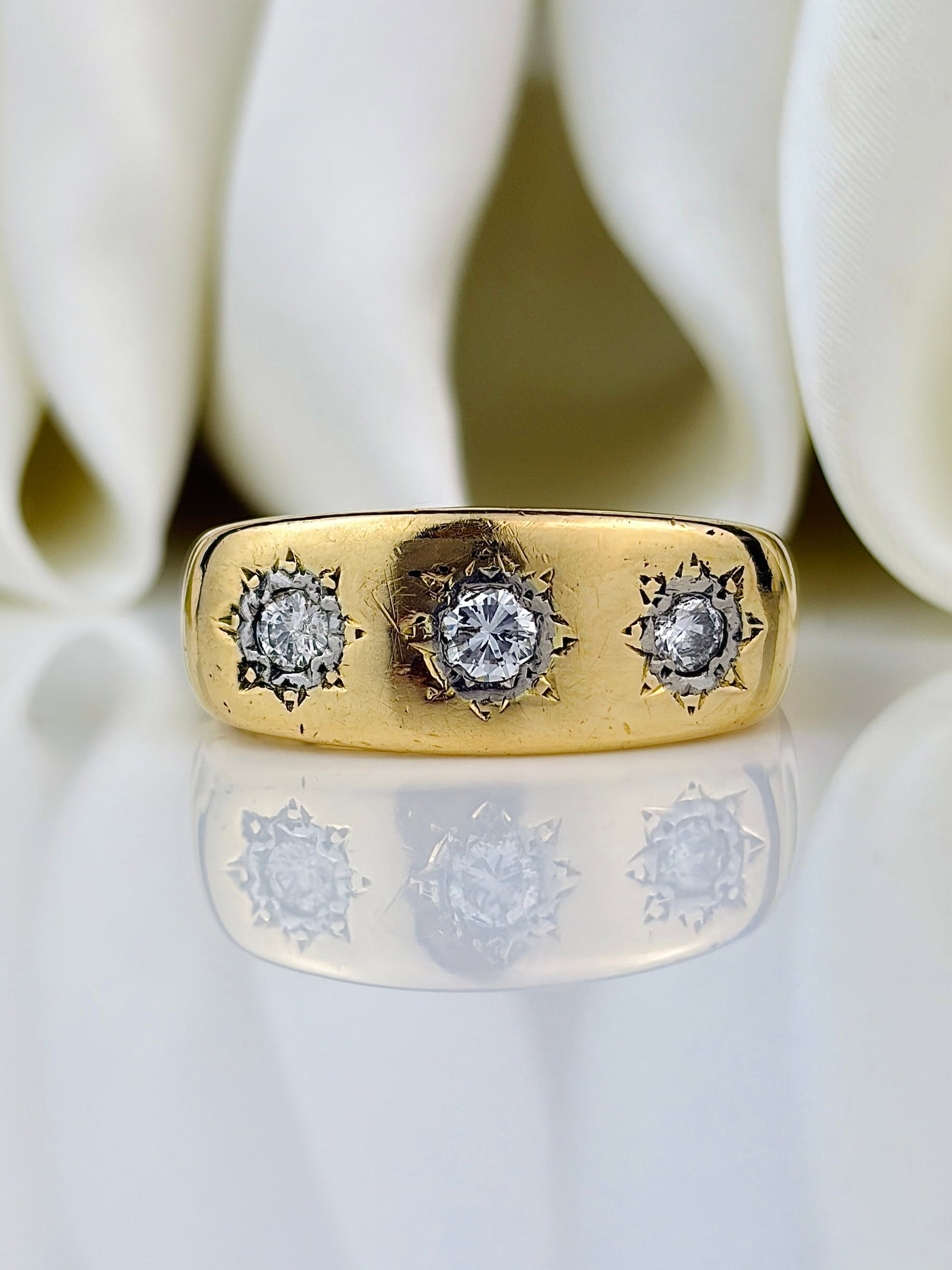 Chunky Vintage c.1968 Diamond and 18 Carat Gold Three Stone Star Setting Ring: Vintage c.1968 Diamond and 18 Carat Gold Three-Stone Star Setting Ring This gorgeous 18ct gold band holds three diamonds totalling 35pts with the central stone measuring 15pts. They are bright and hav