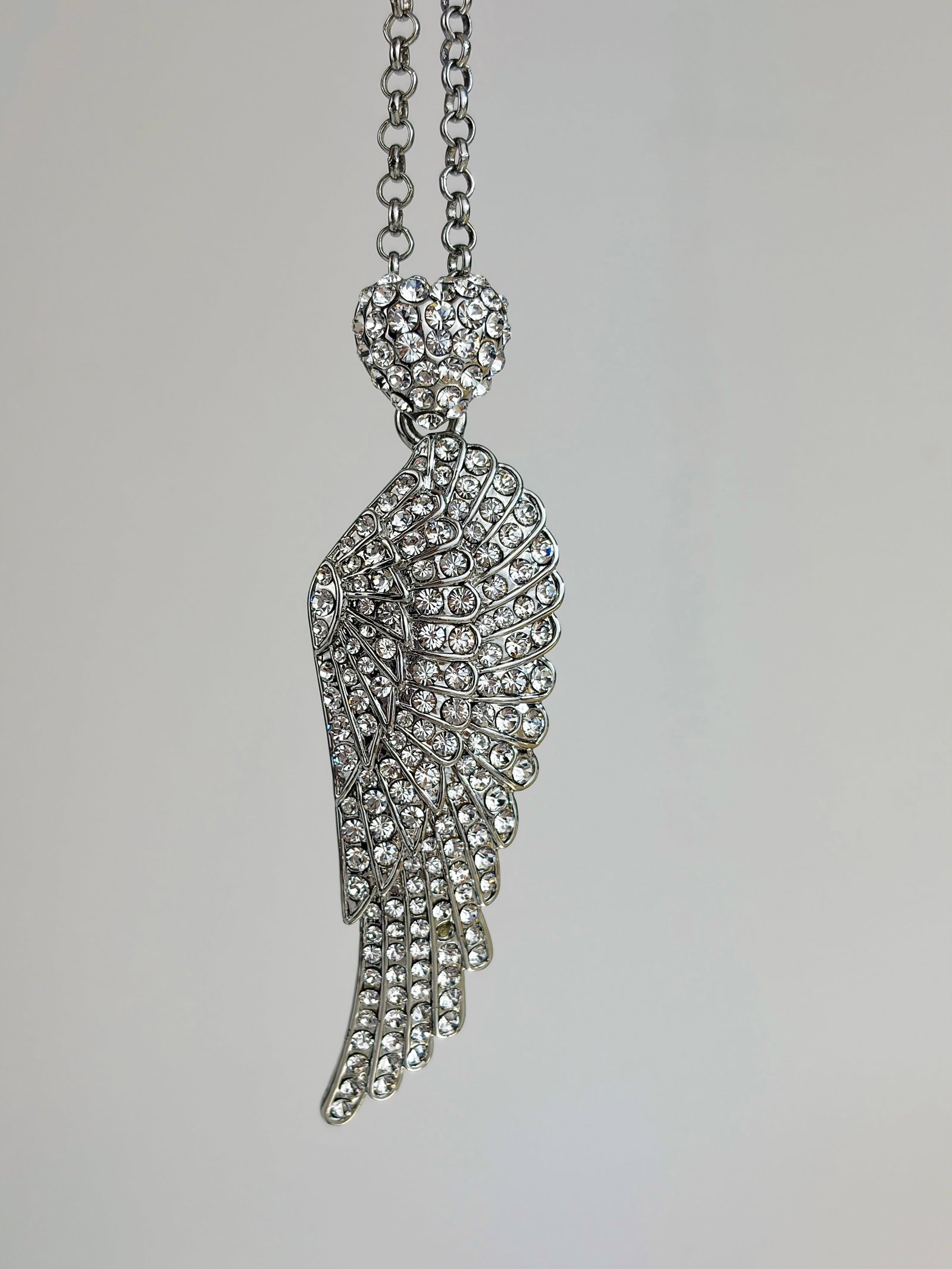 BUTLER & WILSON ANGEL WING AND HEART NECKLACE: BUTLER & WILSON ANGEL WING AND HEART NECKLACE Weight: 37.72g Size: Length 73.5cm drop 93mm Condition: Very good overall condition. Some signs of wear are expected given the piece’s