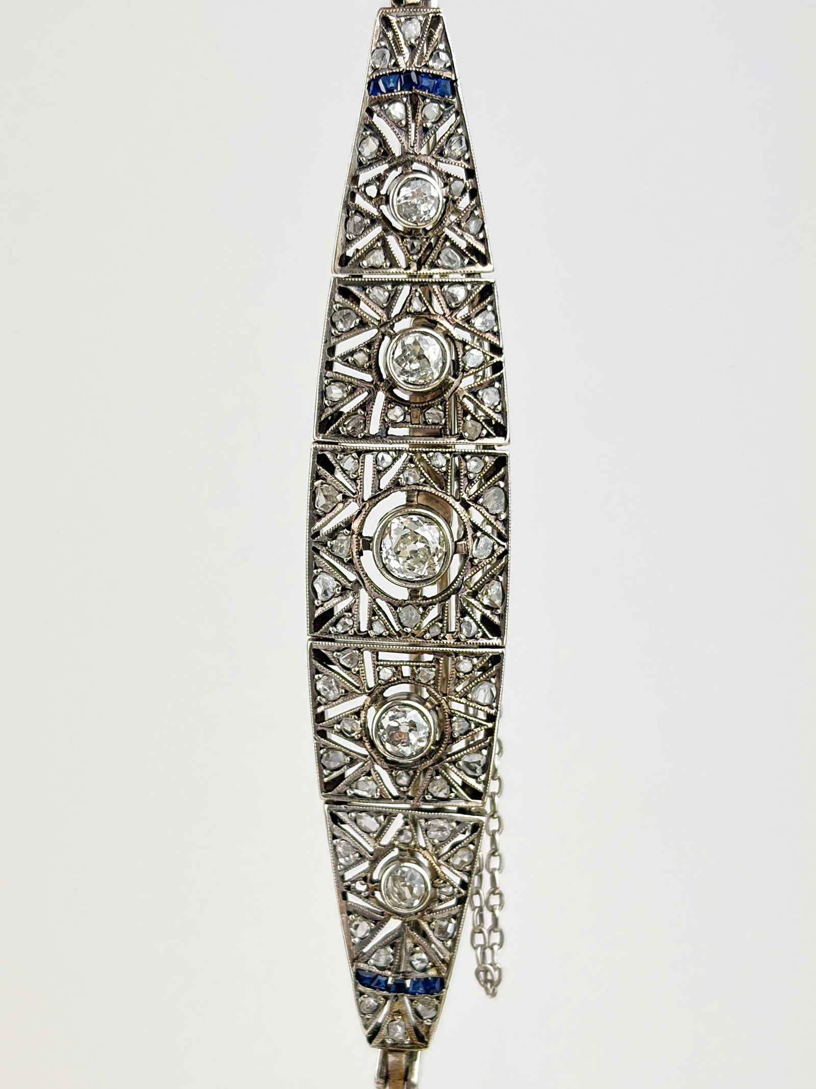 ANTIQUE ART DECO ERA DIAMOND AND SAPPHIRE BRACELET IN PLATINUM: ANTIQUE ART DECO ERA DIAMOND AND SAPPHIRE BRACELET IN PLATINUM A truly exquisite diamond bracelet crafted in the art deco era, adorned with the most amazing diamonds, and sapphire details! Also has a 