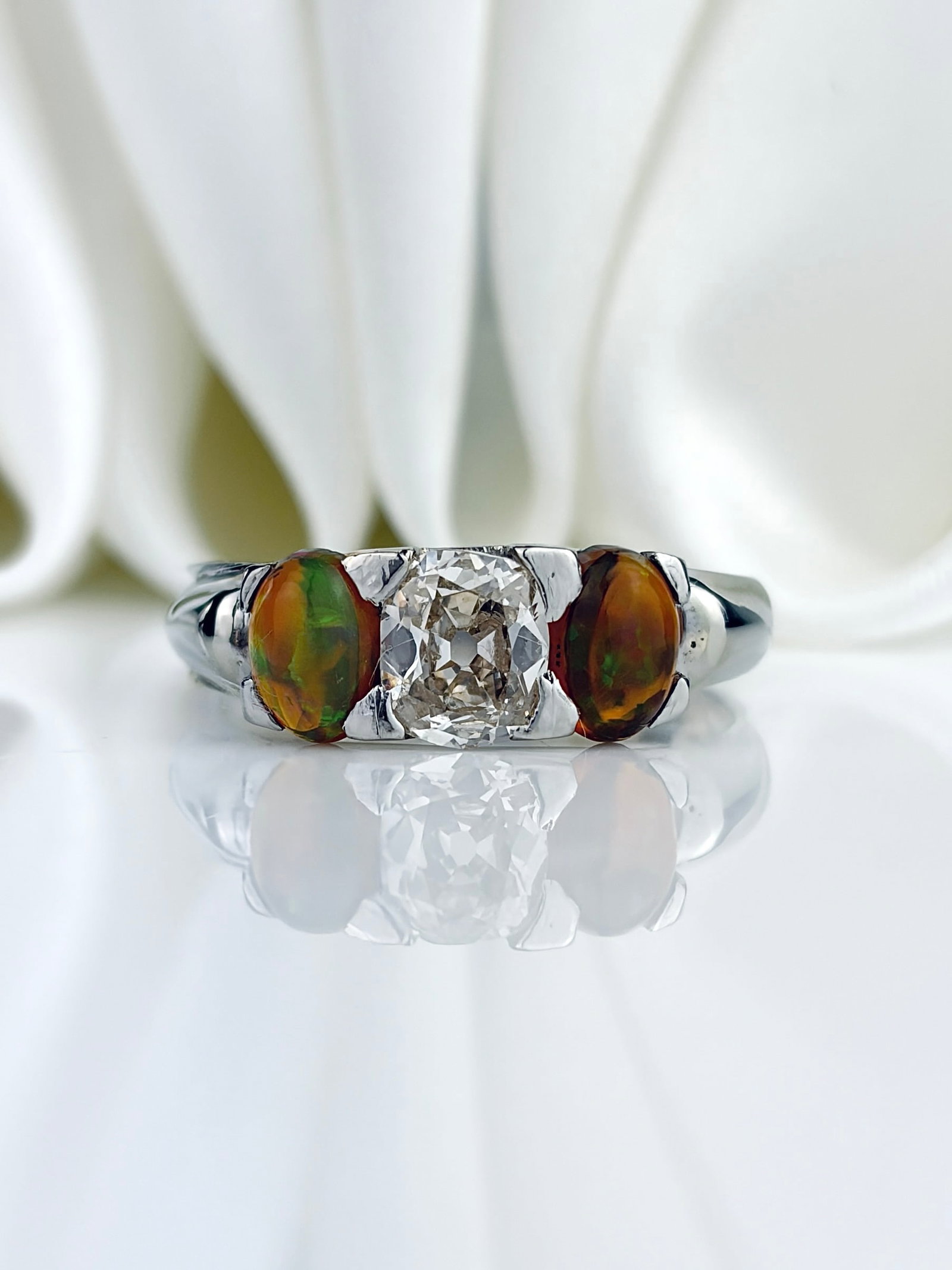 Incredible Black Opal and Diamond 3 Stone Ring in White Gold: Incredible Black Opal and Diamond 3 Stone Ring in White Gold A show stopping ring with two mesmerising black opals either side of a sparkling central diamond!