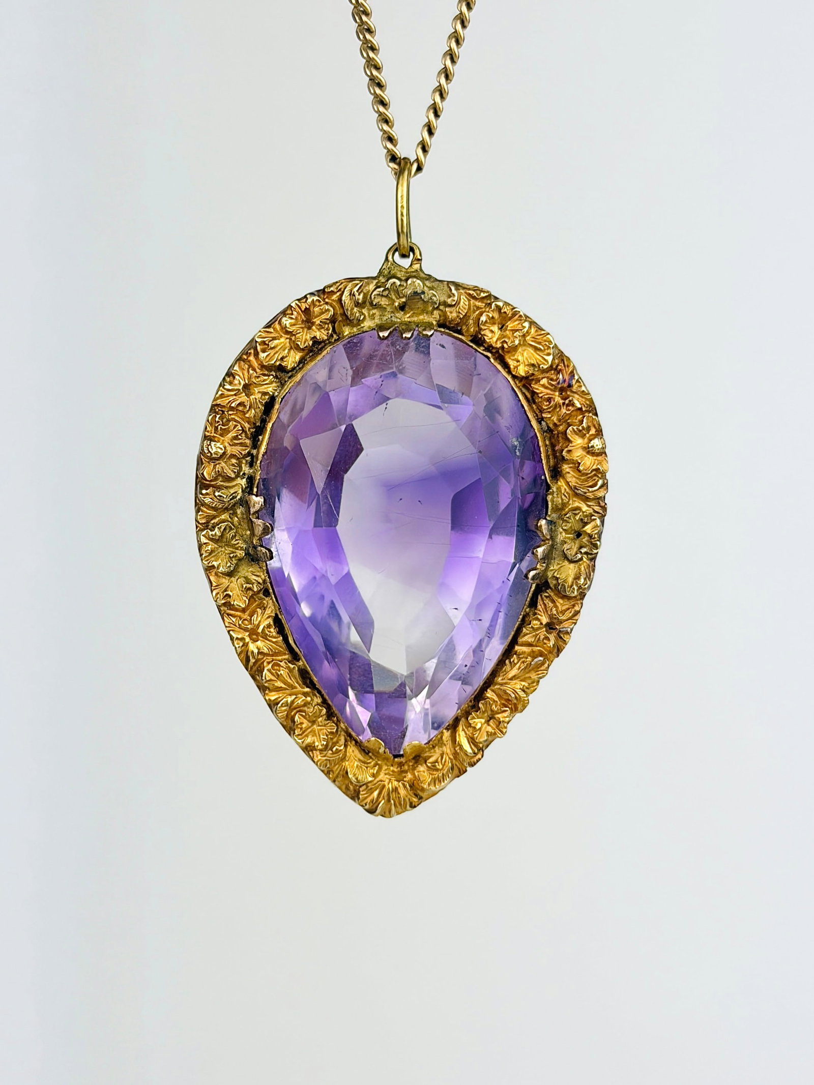 Antique Georgian Pear Cut Amethyst Pendant in Gold: Antique Georgian Pear Cut Amethyst Pendant in Gold Stunning, intricate gold work surrounding a bright amethyst stone! Weight: 7.24g Size: 37x24x11.5mm Materials: Gold, amethyst Hallmarks: None