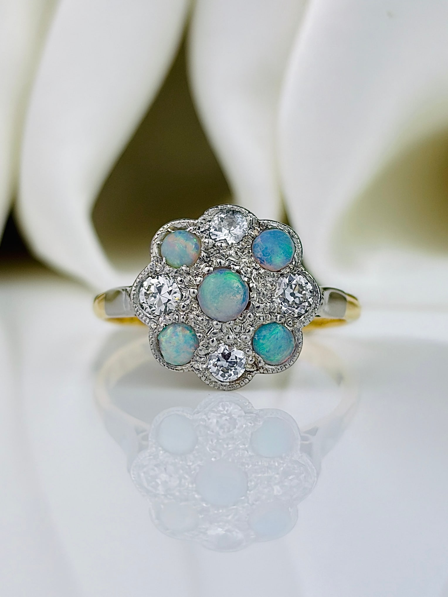 Art Deco 18ct Gold and Platinum Opal and Diamond Panel Ring: Art Deco 18ct Gold and Platinum Opal and Diamond Panel Ring This gorgeous ring holds five opals and four diamonds, with the diamonds totalling approximately 60pts. The stones are set in platinum and
