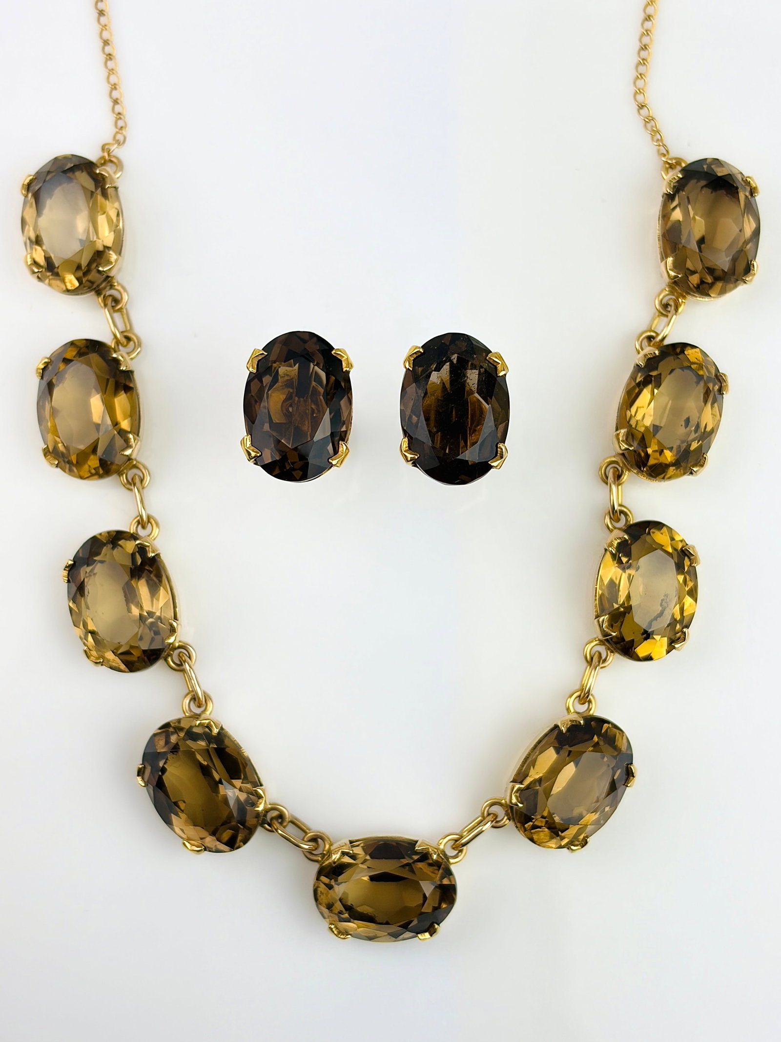 VINTAGE 9CT YELLOW GOLD SMOKEY QUARTZ NECKLACE AND EARRINGS SUITE: VINTAGE 9CT YELLOW GOLD SMOKEY QUARTZ NECKLACE AND EARRINGS SUITE A lovely set of earrings and a necklace! Marked from Scotland! Weight: Necklace 22.11g, Earrings 4.6g Size: Necklace 40.5x1cm,