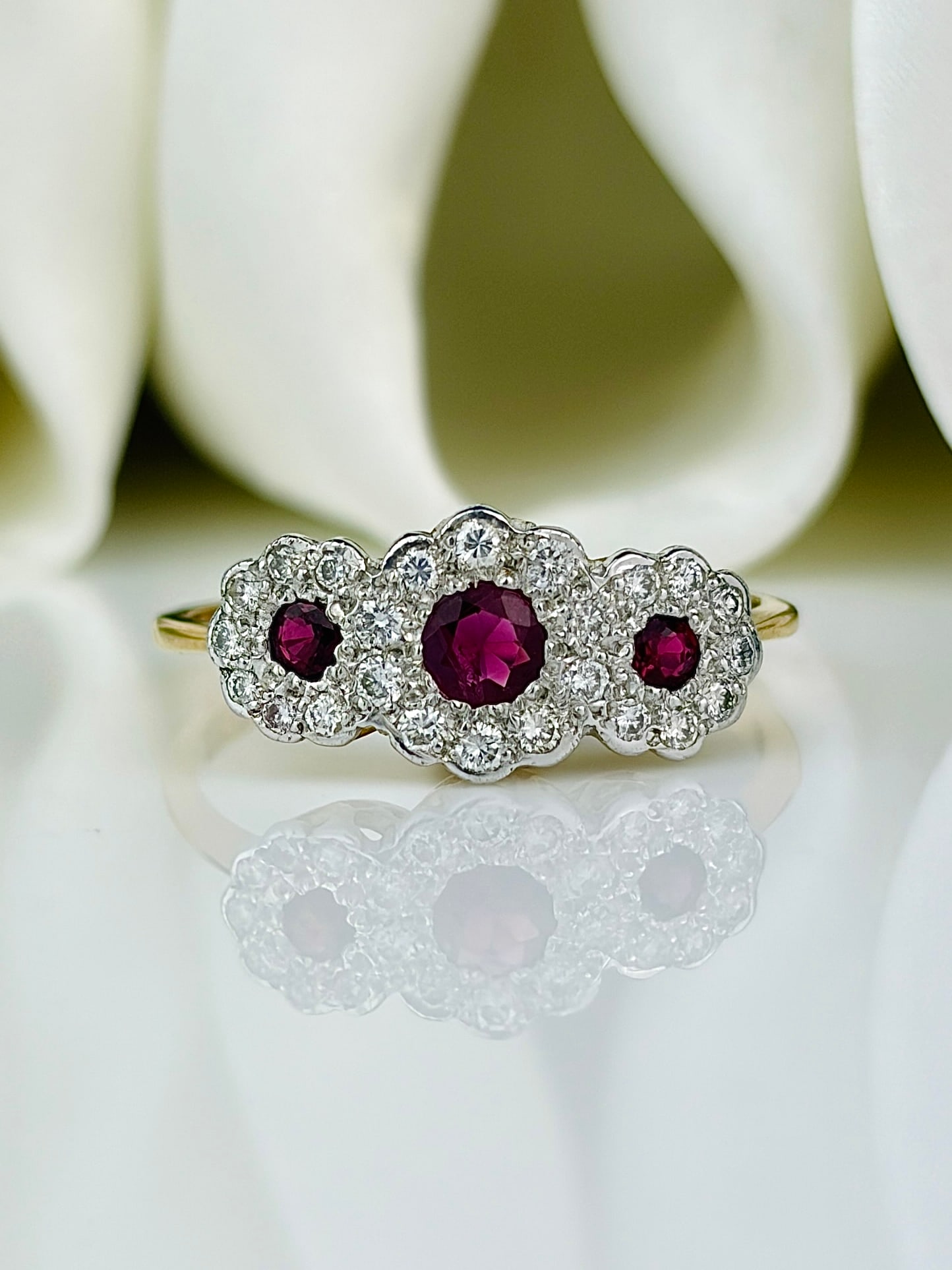 Vintage Ruby and Diamond 18 Carat Gold Triple Cluster Ring: Vintage Ruby and Diamond 18 Carat Gold Triple Cluster Ring The sparkle of this ring is impossible to catch in a photo! It is simply stunning! The rubies at the centre of each cluster are a deep, rich 