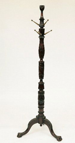 American Empire Carved Coat Stand: early 20th c. The frame finial standard carved with leaf motifs, raised on a tripod cabriole leg base ending in paw feet. Mahogany. 71" h. Condition: expected wear, one missing hook